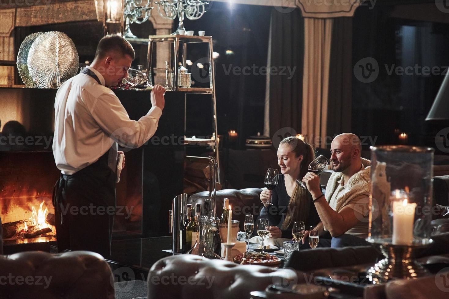 Smells pretty good. Girl with her boyfriend have nice evening at beautiful restaurant photo