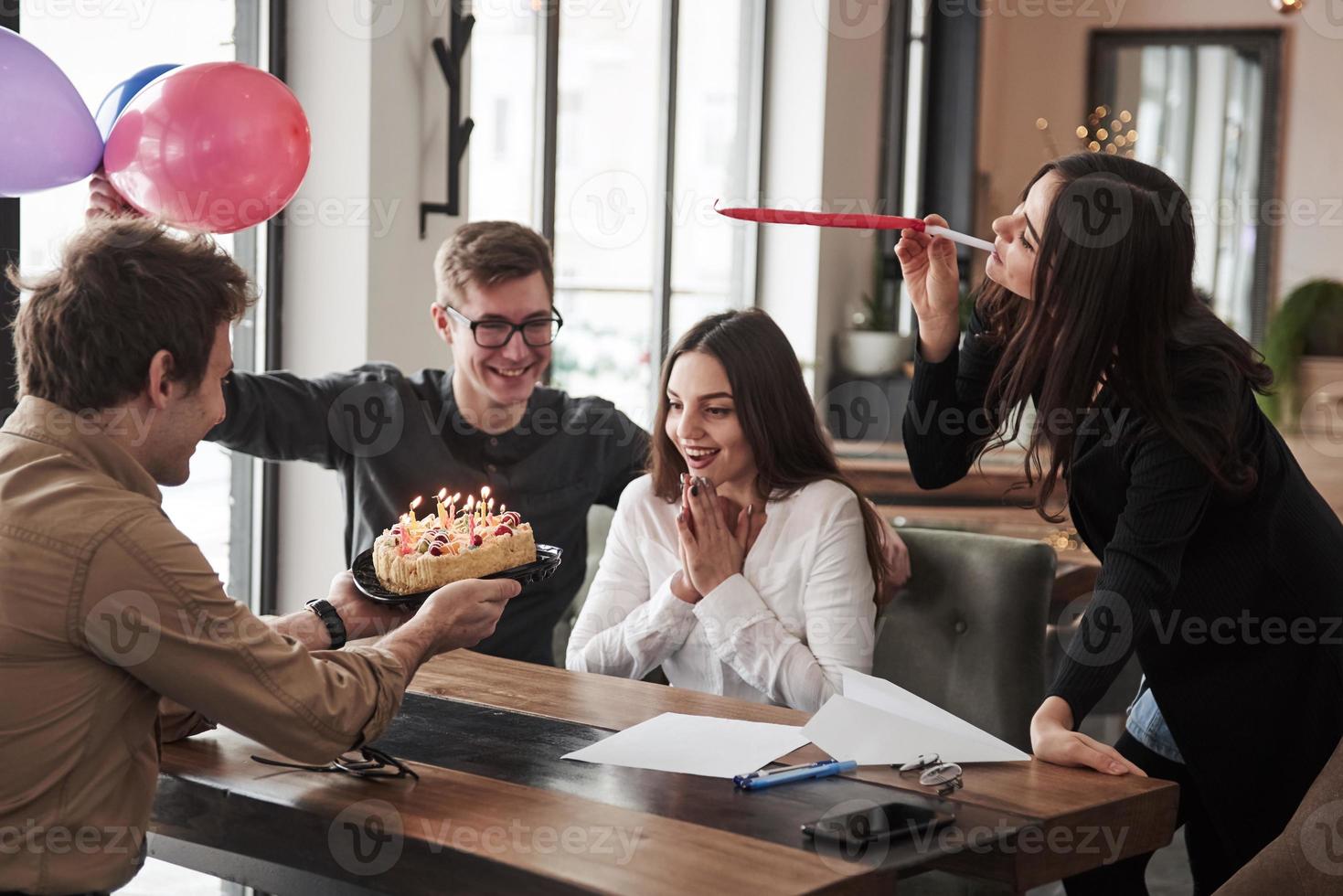 Cake and balloons. One of employees have birthday today. Friendly coworkers decides to make surprise for her photo