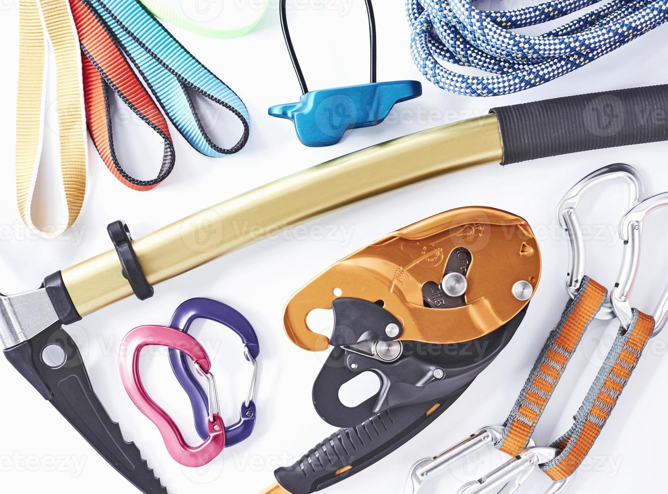 Variety of colors. Top view. Climbing equipment for the safeness lying on the white table. Conception of extreme sports photo