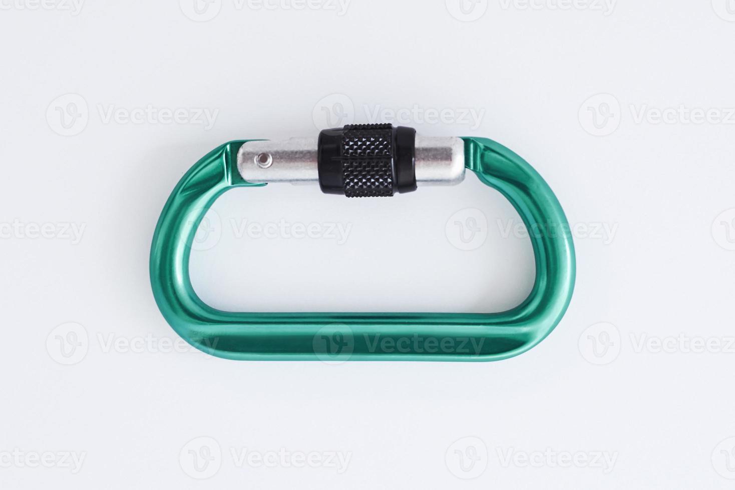 Touristic extreme sports. Isolated photo of climbing equipment - green colored part of carabiner