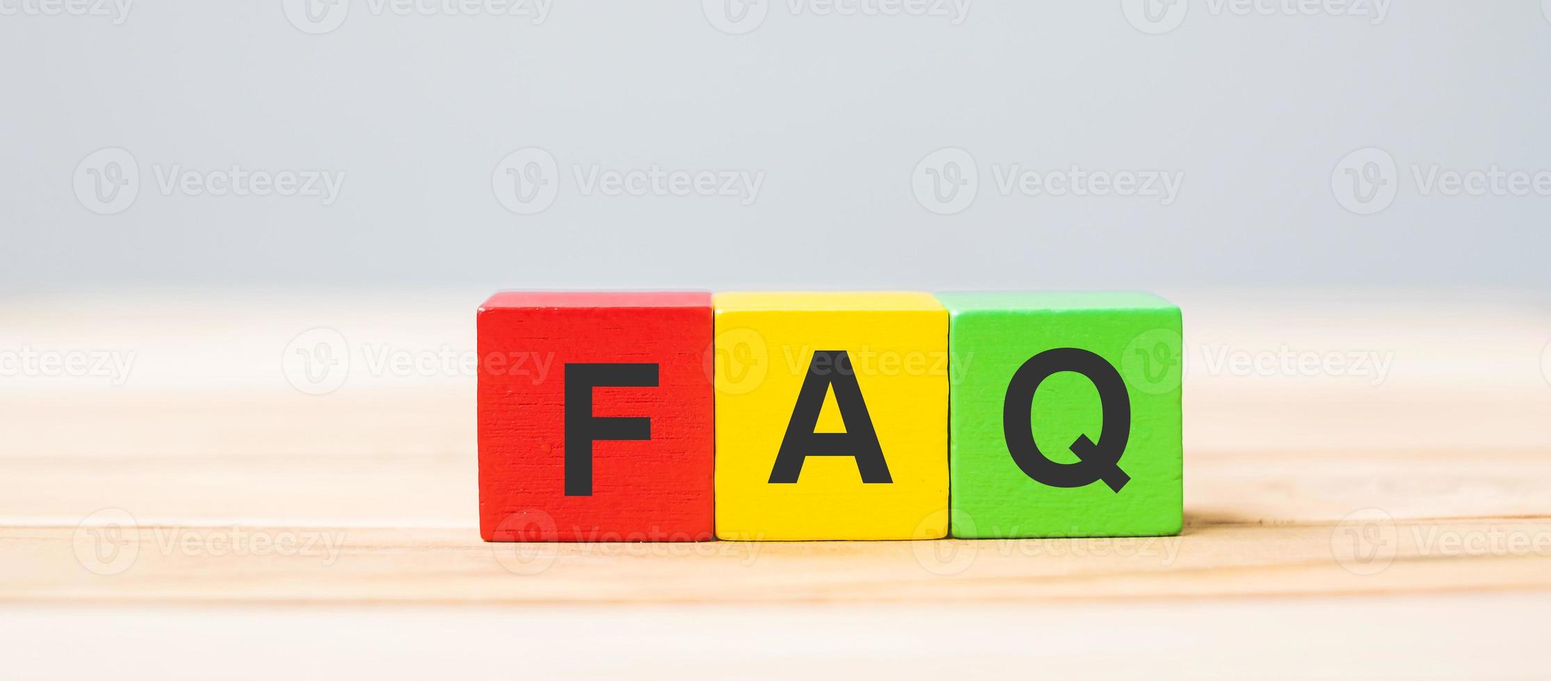 wooden cube blocks with FAQ text on table background. Financial, marketing and business concepts photo