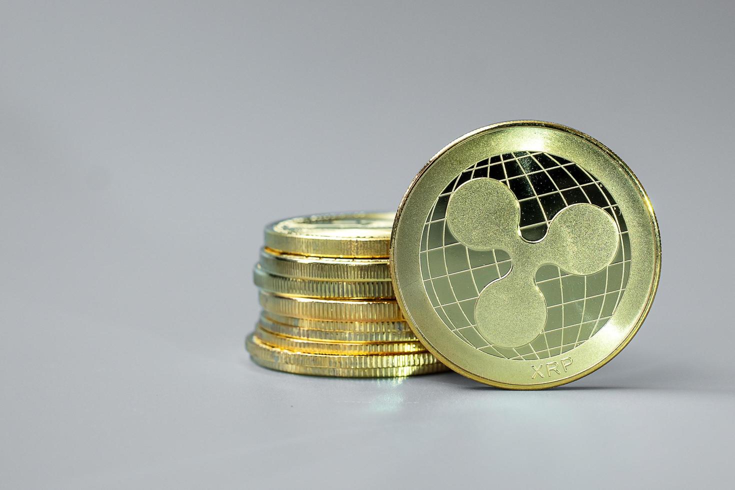 golden Ripple cryptocurrency coin stack, Crypto is Digital Money within the blockchain network, is exchanged using technology and online internet exchange. Financial concept photo