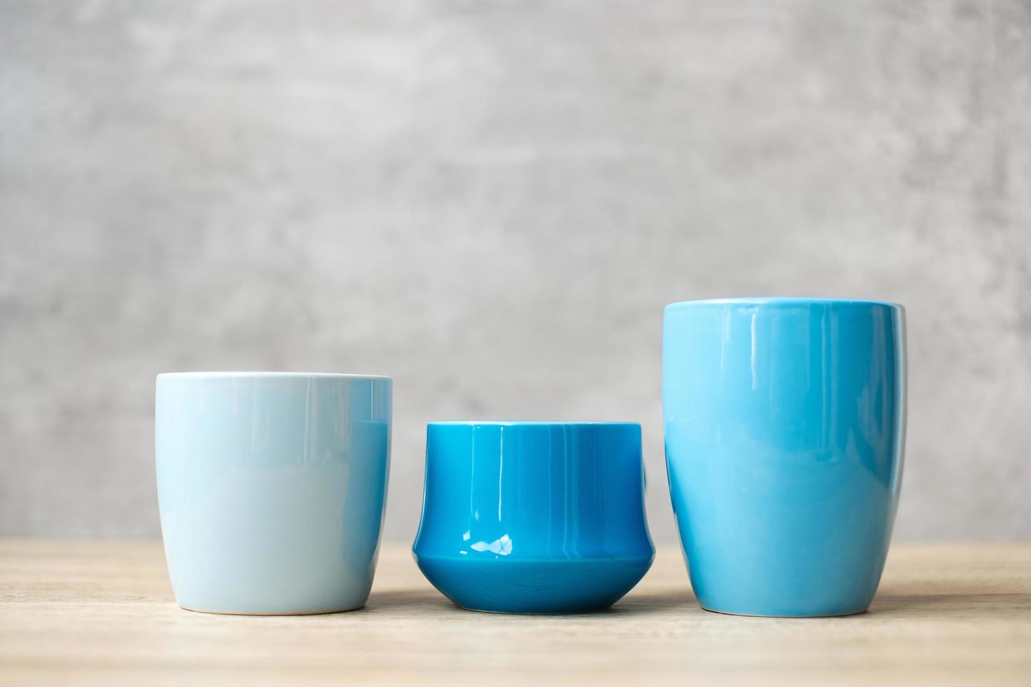 Blue coffee cup and tea mug on wood table background in the morning, Blank copy space for text. International coffee day and daily routine concept photo