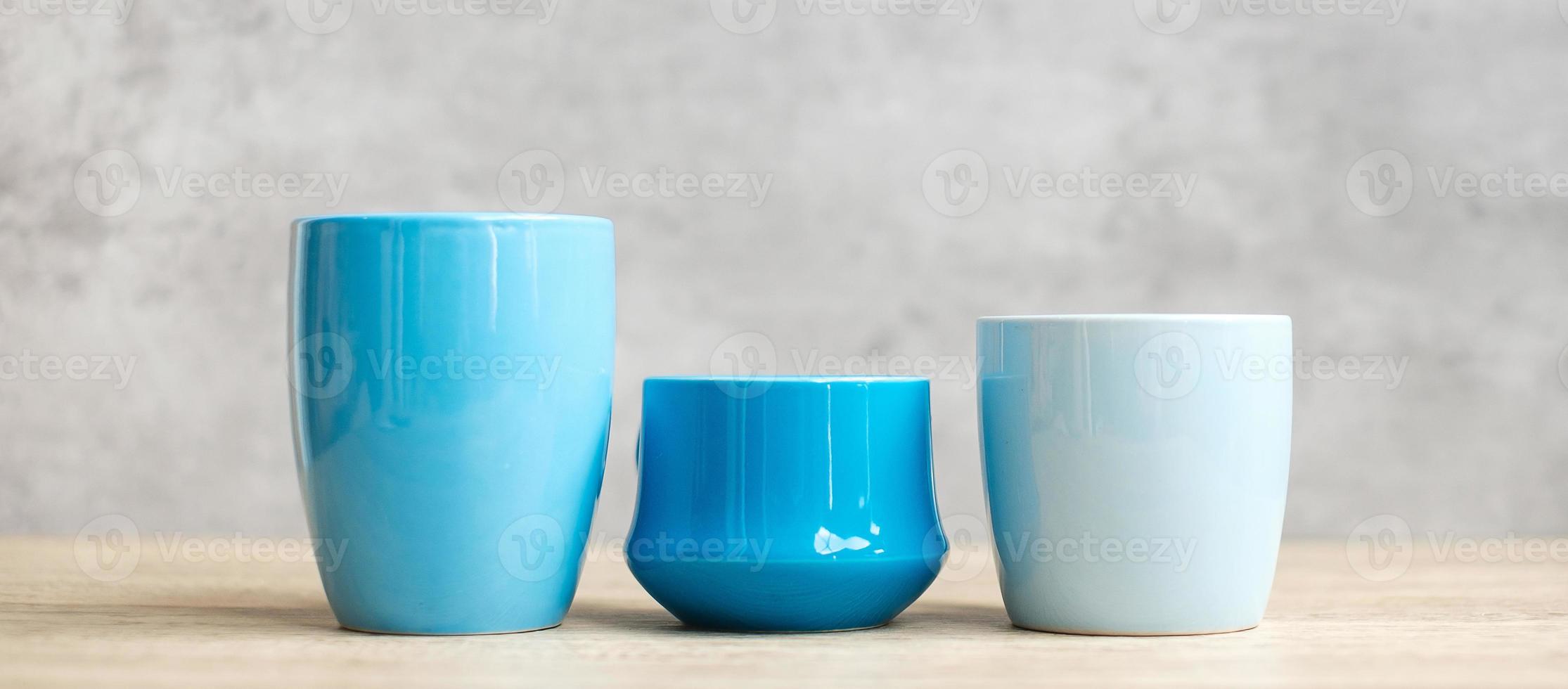 Blue coffee cup and tea mug on wood table background in the morning, Blank copy space for text. International coffee day and daily routine concept photo