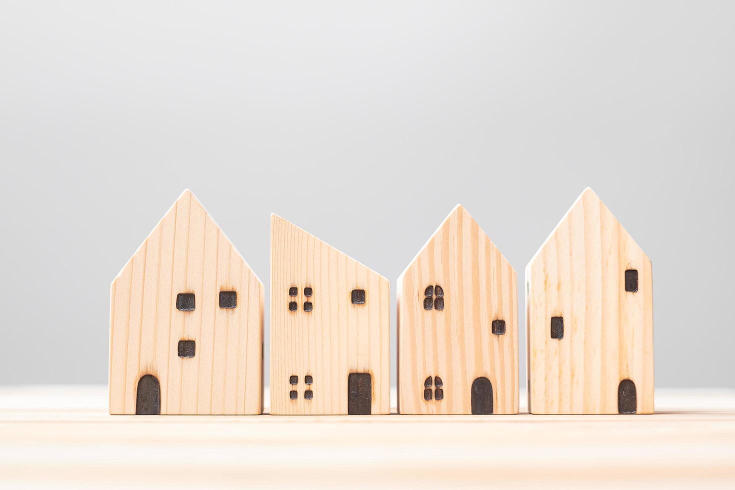 wooden house model on table background. Home, Crisis, Economic recession, Homeless, Real Estate, Buy or Rent and Property concept photo