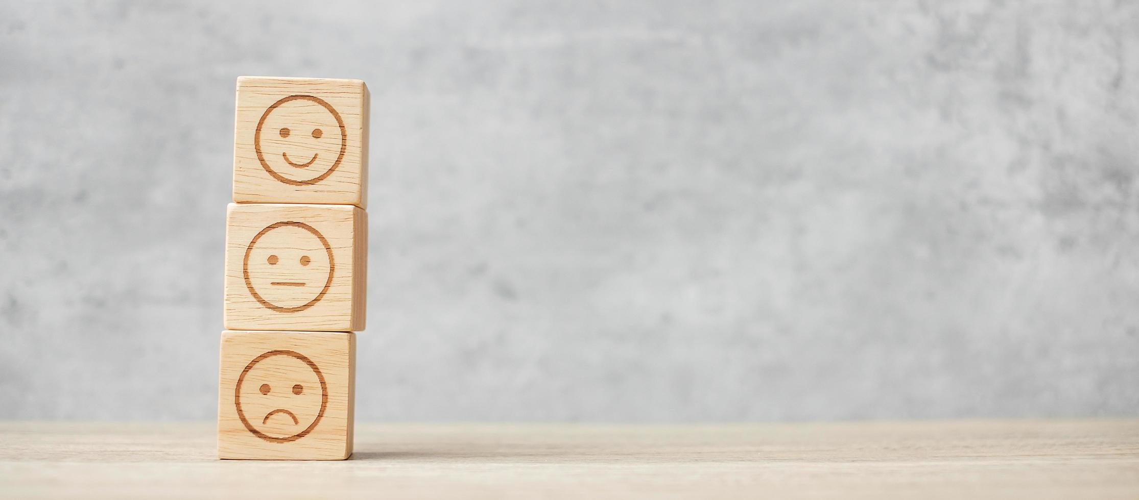 emotion face symbol on wooden blocks. mood, Service rating, ranking, customer review, satisfaction, evaluation and feedback concept photo