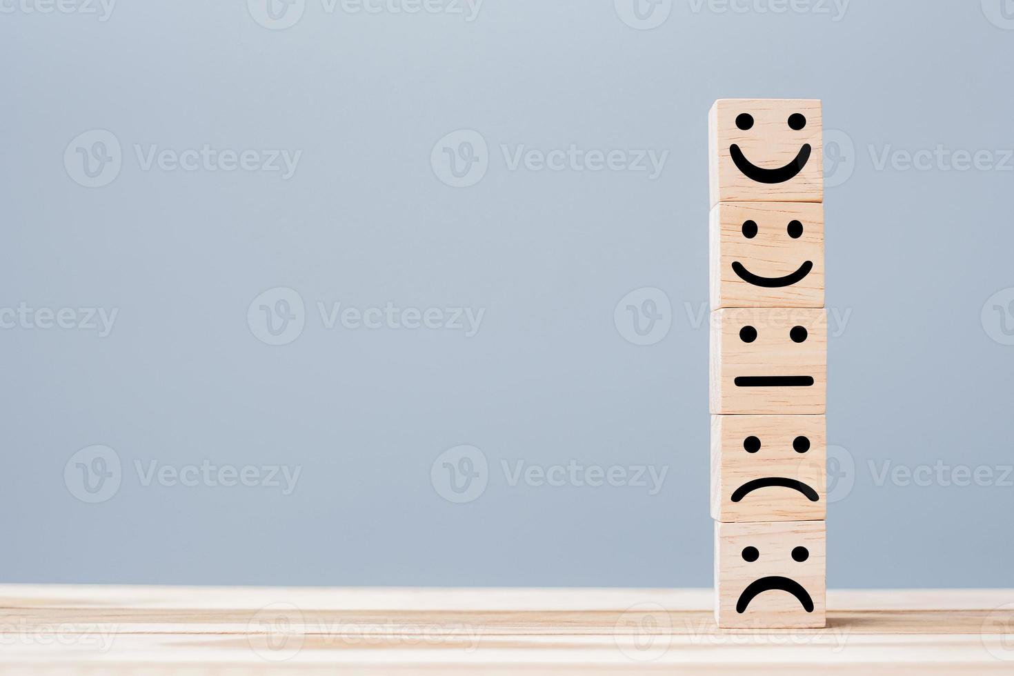smile face symbol on yellow wooden cube blocks. Emotion, Service rating, ranking, customer review, satisfaction and feedback concept photo