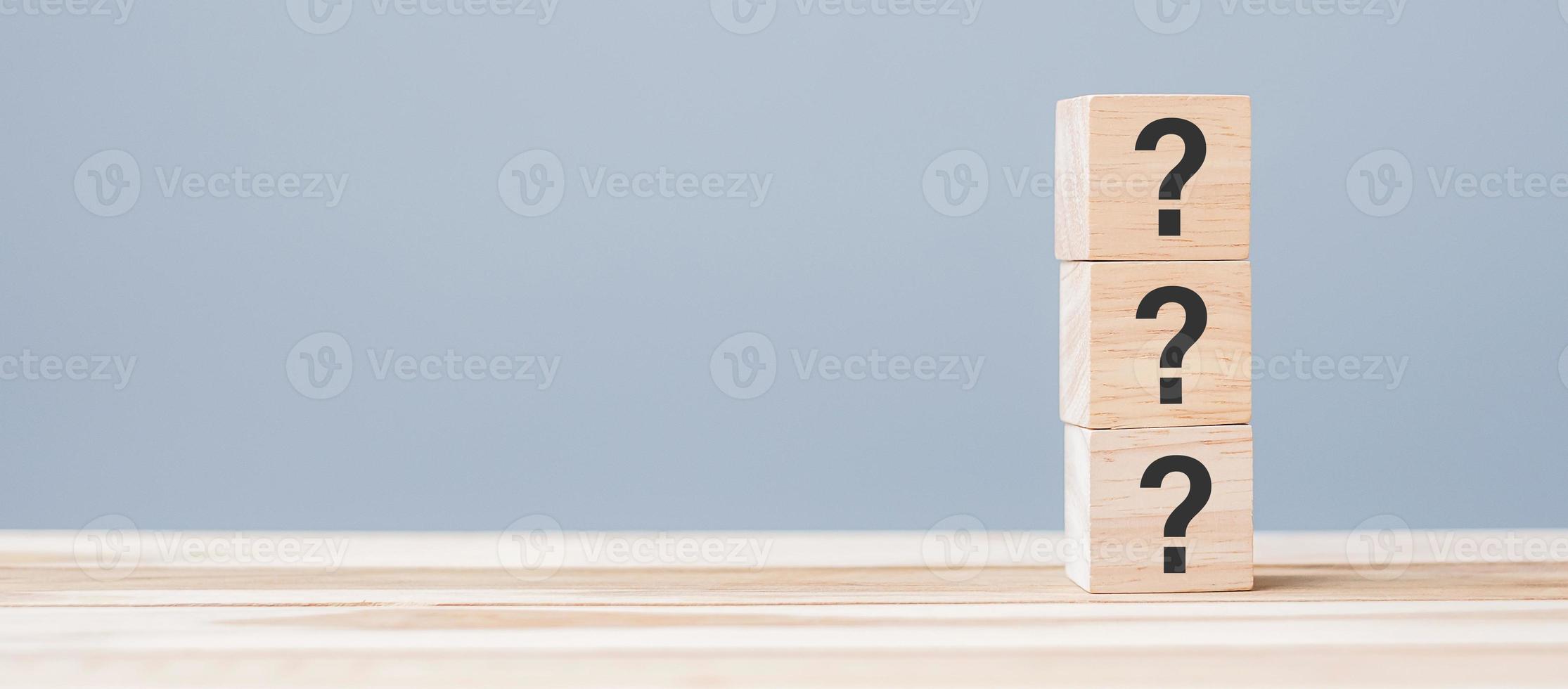 Questions Mark on wooden cube block on table background. FAQ, Answer, Q and A, Information, Communication and interrogation Concepts photo