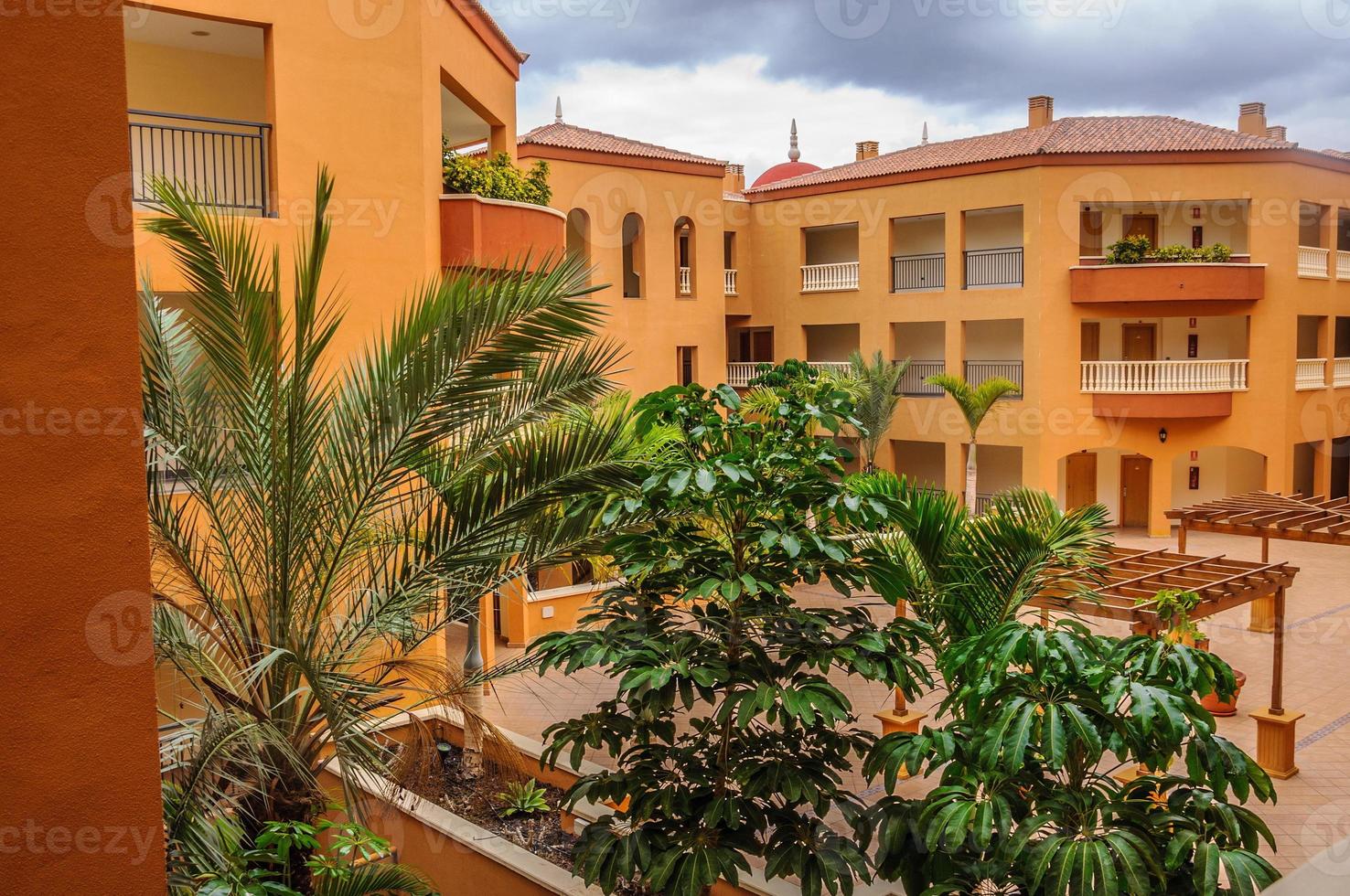 Hotel courtyard with palms and trees in Tenerife, Spain photo