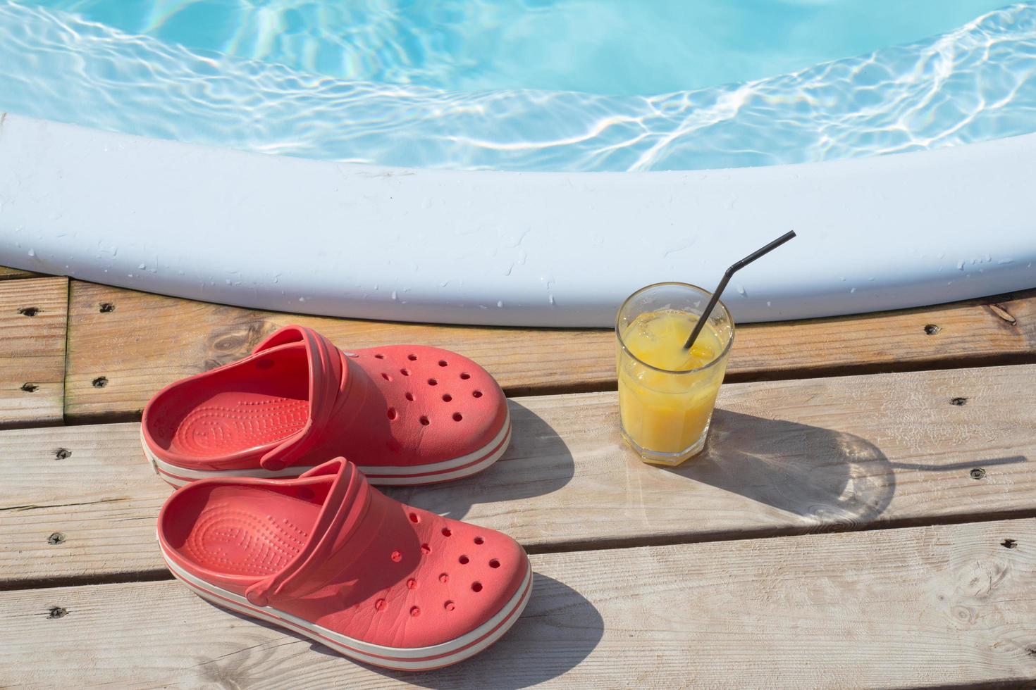 glass of juice by the pool photo
