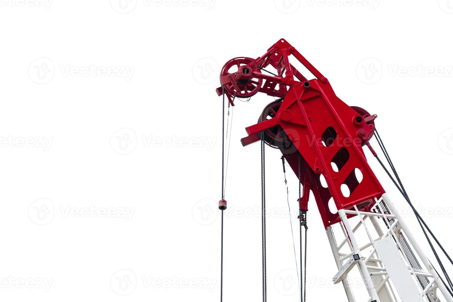 Construction crane for heavy lifting isolated on white background. Construction industry. Closeup red-white crane for lift equipment. Crane for rent. Crane dealership for construction business. photo