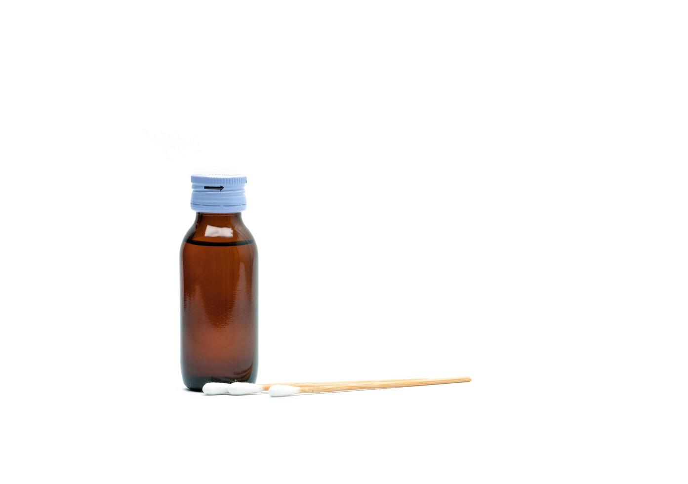 Cotton sticks and antiseptic solutions in amber glass bottle isolated on white background. Concept of Umbilical cord care for helps prevent infection. Infant's umbilical cord cleaning care equipment. photo