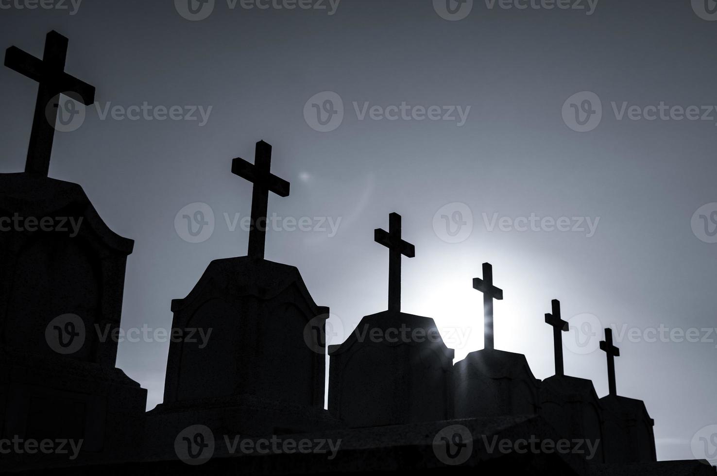 Cemetery or graveyard in the night with dark sky. Headstone and cross tombstone cemetery. Rest in peace concept. Funeral concept. Sadness, lament, and death background. Spooky and scary burial ground. photo