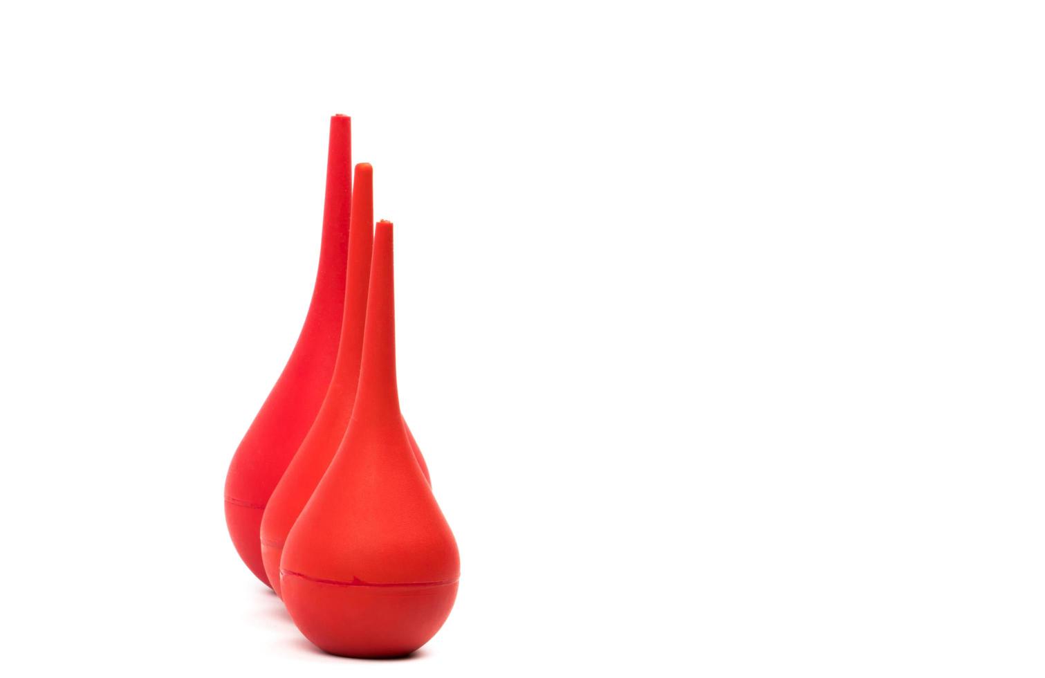 Red rubber syringe ball isolated on white background. Nasal aspirator. Baby ear syringe ball. Snot sucker and mucus sucker. Laboratory tool. Rubber suction syringe bulb. Ear washing squeeze bulb. photo