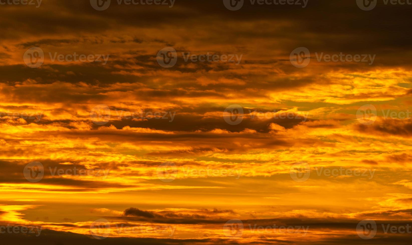 hermoso cielo al atardecer. cielo dorado al atardecer con un hermoso patrón de nubes. nubes anaranjadas, amarillas y oscuras en la noche. libertad y fondo tranquilo. belleza en la naturaleza. escenario poderoso y espiritual. foto