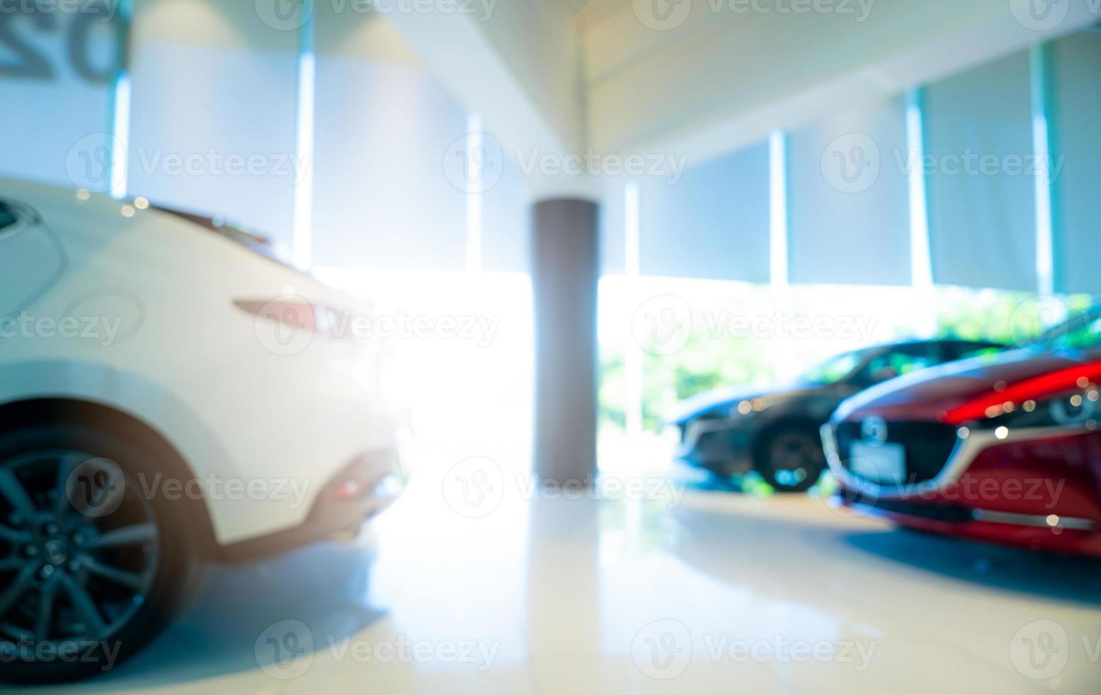 Blurred red and white car parked in modern showroom. Car dealership and auto leasing concept. Automotive industry. Modern luxury showroom. New car parked in showroom. Electric automobile technology. photo