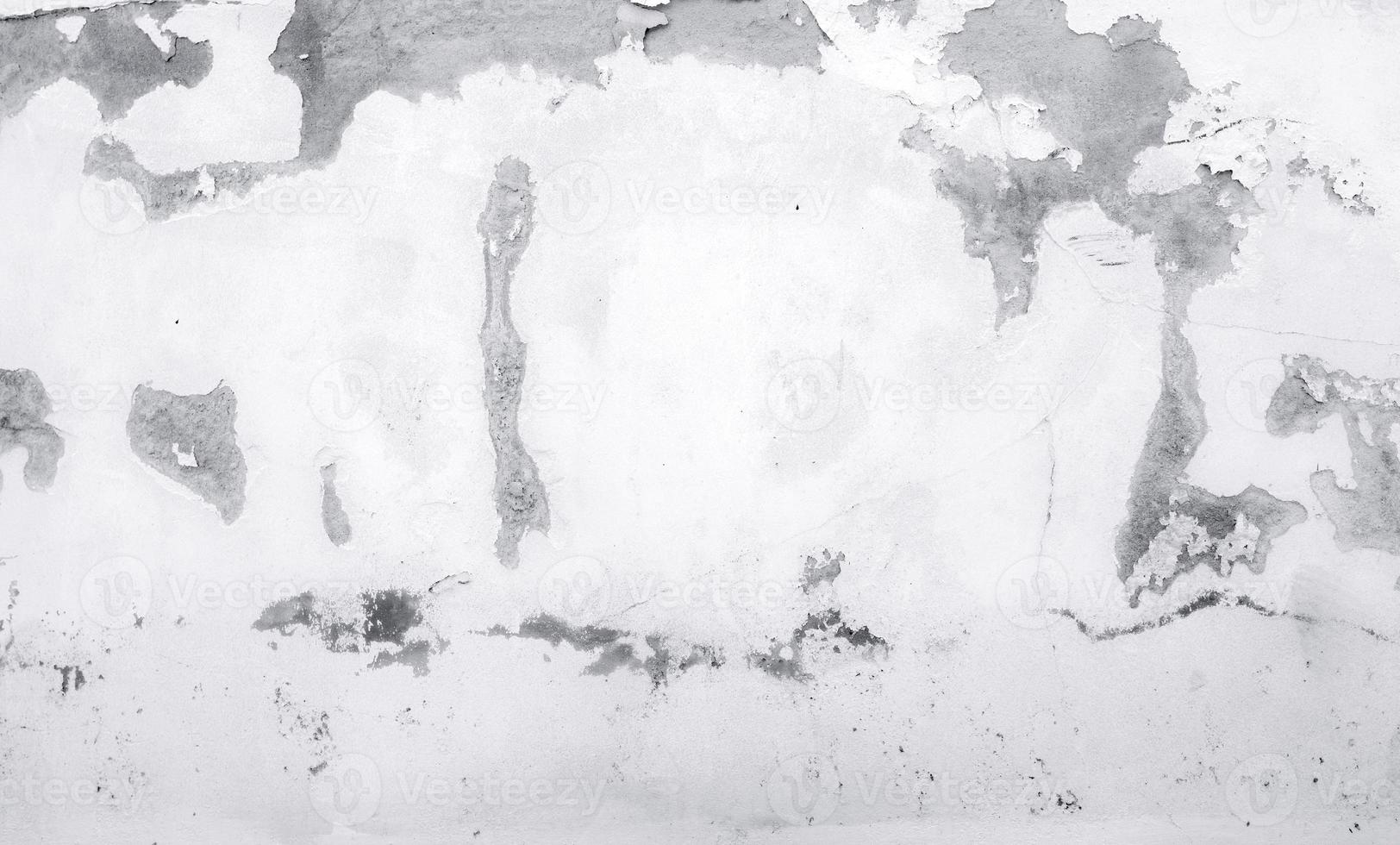 Old white concrete wall are peeling. Painted concrete wall abstract texture background. Deteriorated over time. Cracked cement wall. Empty white wall texture background for minimal life. photo