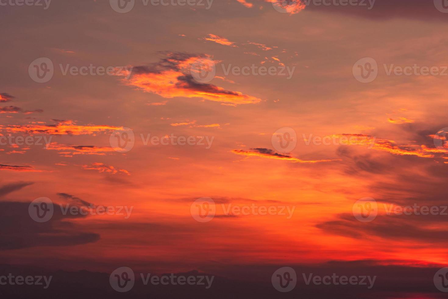 Dramatic red and orange sky and clouds abstract background. Red-orange clouds on sunset sky. Warm weather background. Art picture of sky at dusk. Sunset abstract background. Dusk and dawn concept photo