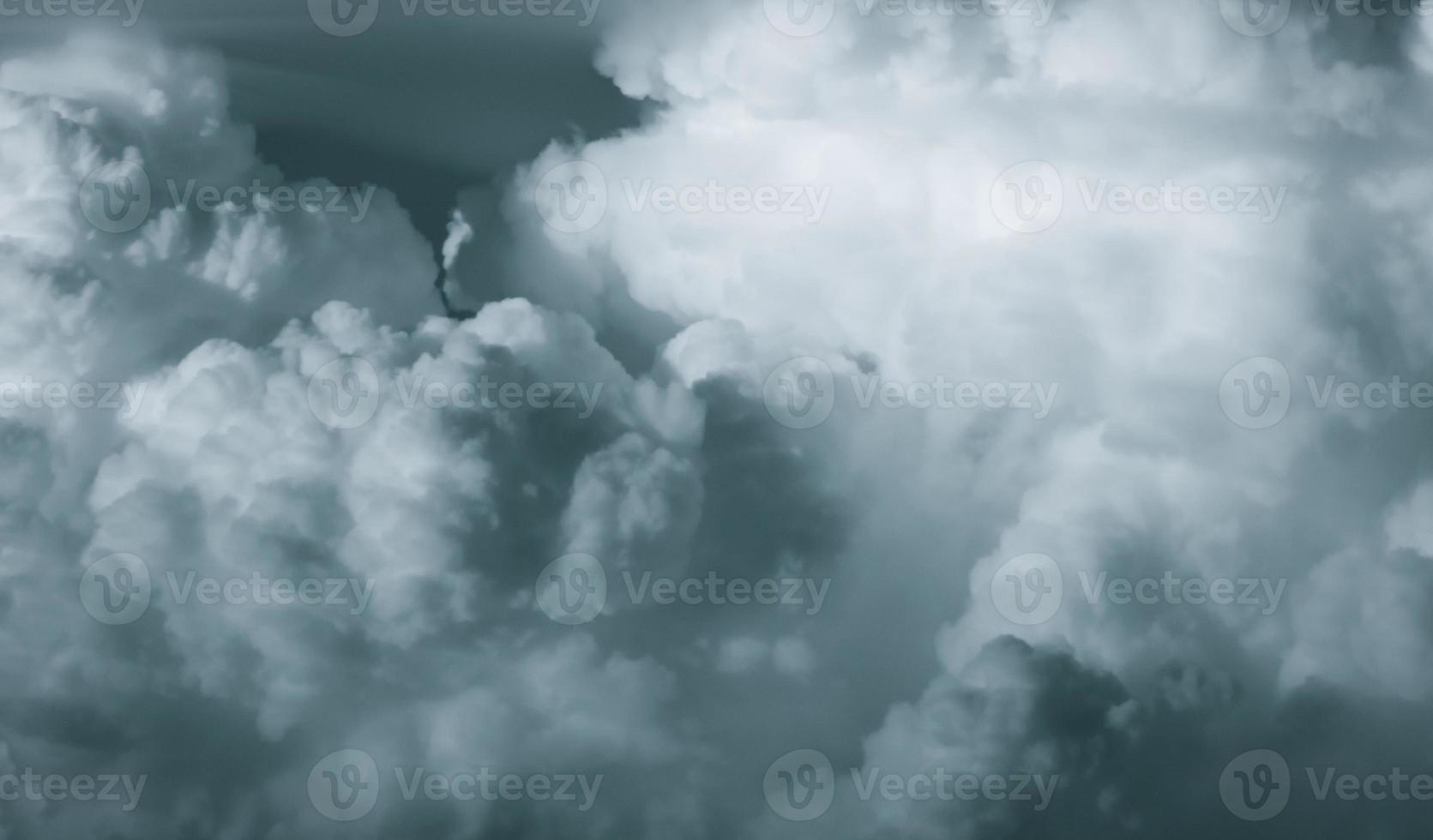 White fluffy clouds on dark sky. Soft touch feeling like cotton. Stormy sky before raining. Beauty in nature. The combination of rain clouds before rain. Close-up group of clouds texture background. photo