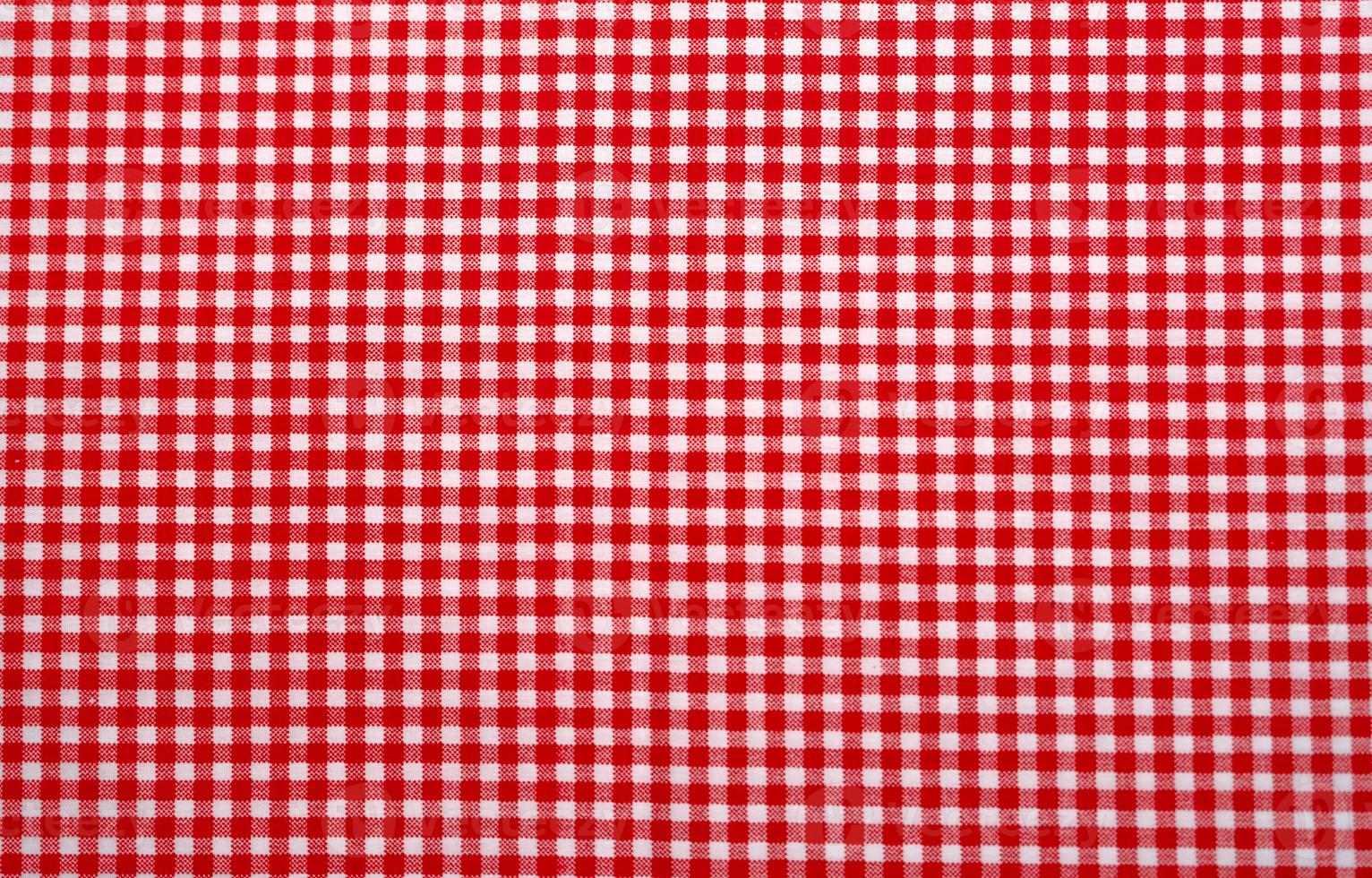 Red and white checkered tablecloth. Top view table cloth texture background. Red gingham pattern fabric. Picnic blanket texture. Red table cloth for Italian food menu. Square pattern of gingham. photo