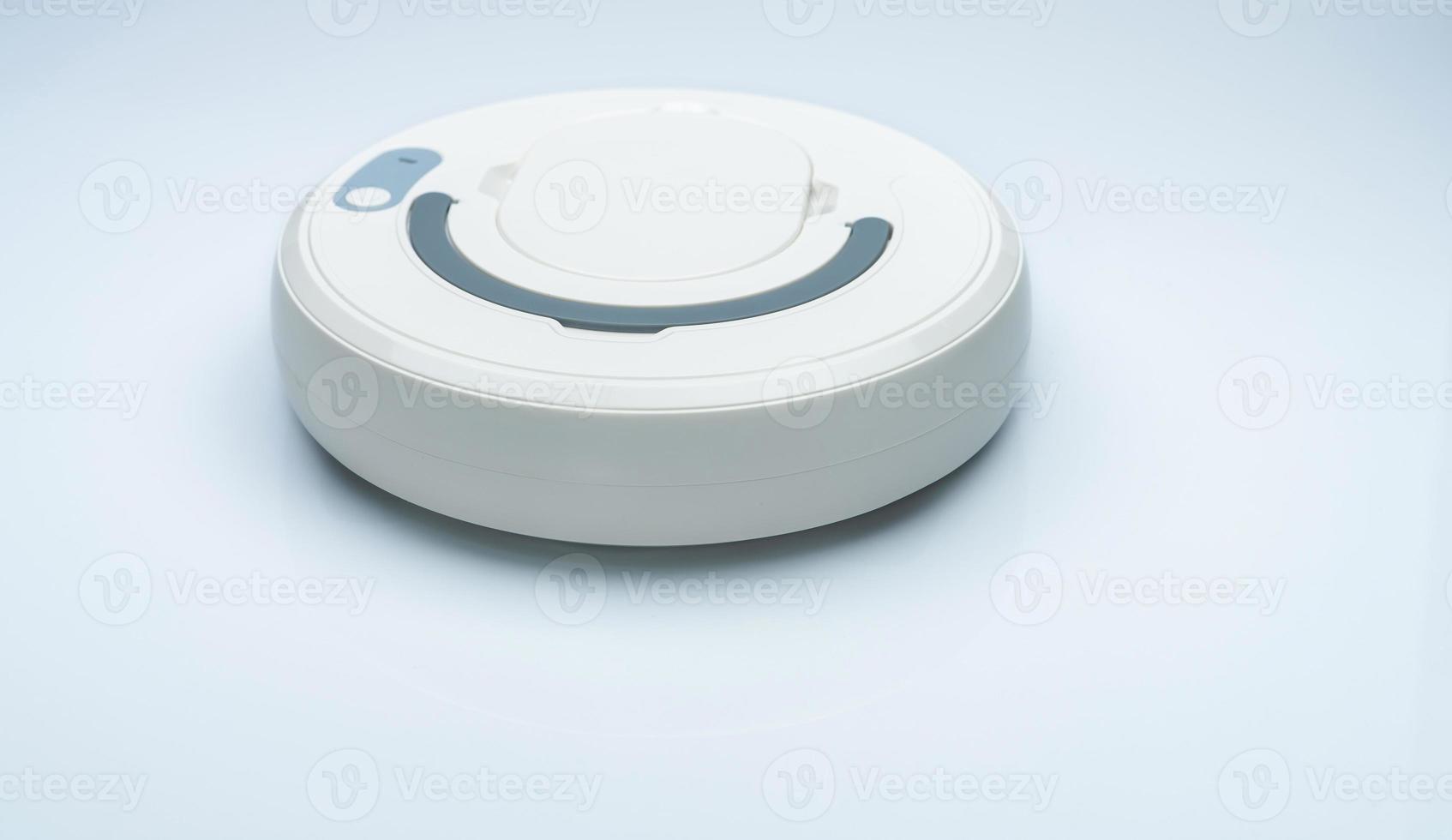 Robot vacuum cleaner isolated on white background. Robot vacuum cleaner for the smart home concept. Cleaning robot for cleaning floor. Wireless device. Smart cleaning technology. Household device. photo