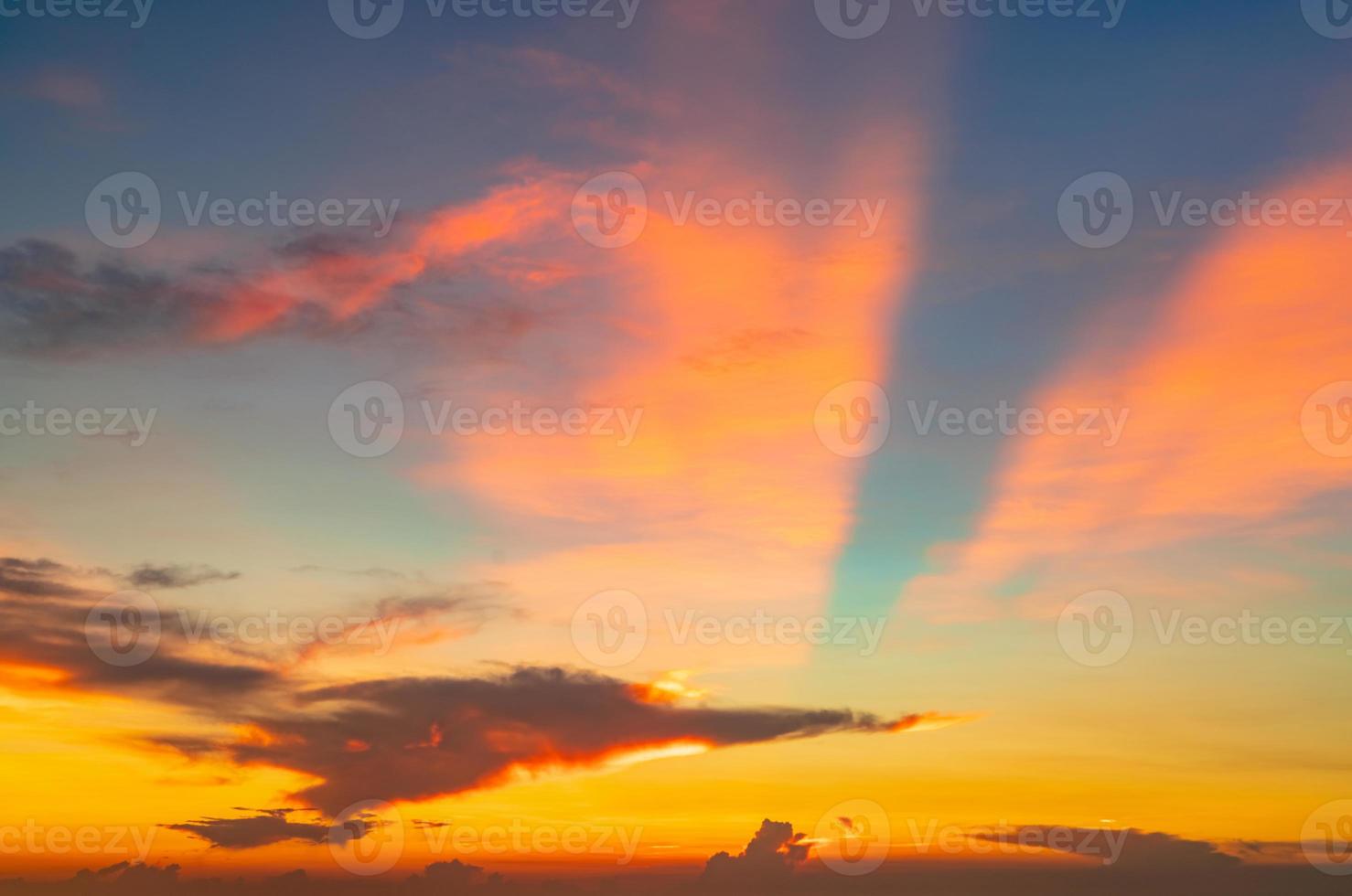 Beautiful sunset sky. Orange and blue sunset sky with beautiful pattern of clouds. Orange, red, and blue clouds at dusk. Freedom and calm background. Beauty in nature. Powerful and spiritual scene. photo