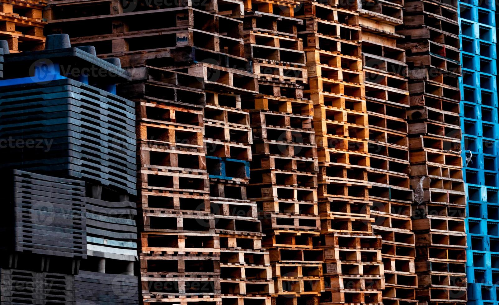 Pile of old wooden pallet. Industrial wood pallet stacked at factory warehouse. Cargo and shipping concept. Wood pallet rack for export delivery industry. Wooden pallet storage warehouse of factory. photo