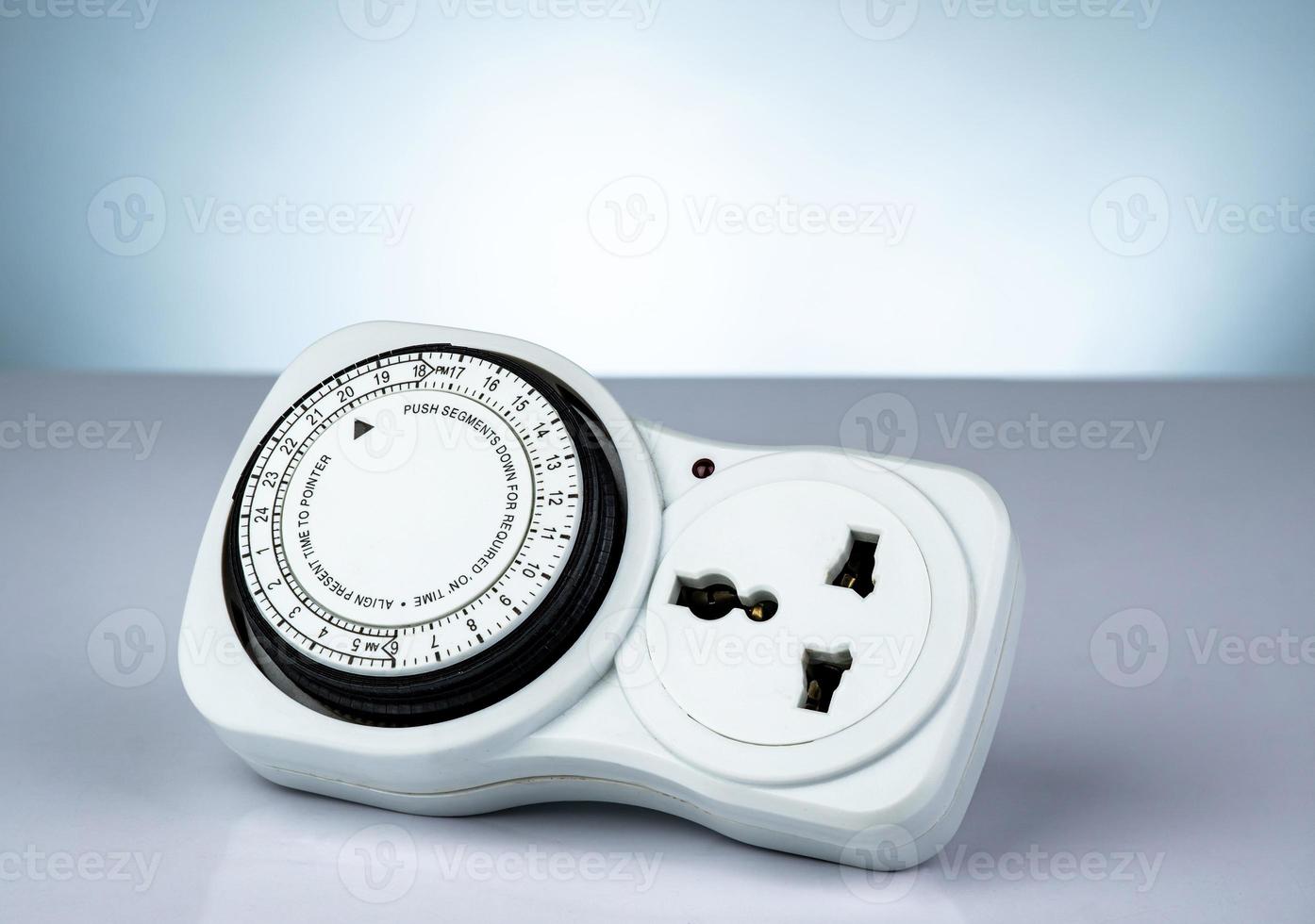 Plug-in timer mechanical 24 hour. Indoor home tools. Plug-in timer socket set isolated on white background. Mechanical outlet timer. Home security supply. Smart home tools. Mechanical timer switch. photo
