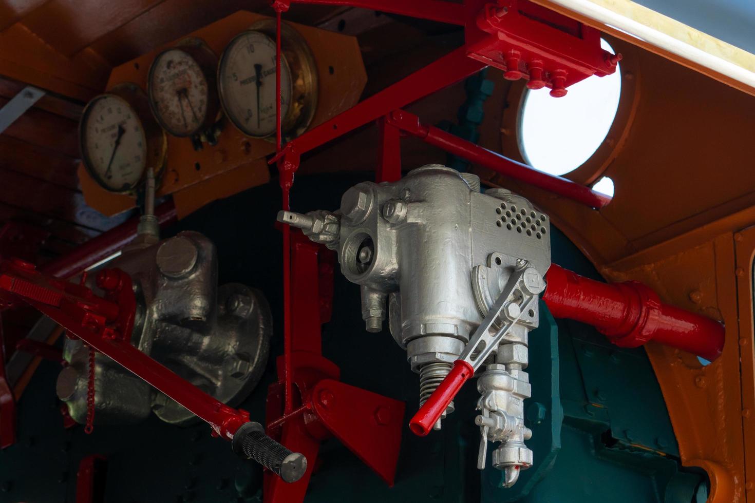 Closeup control valve of steam locomotive. Directional valves allow steam to flow through the steam locomotive engine drive system. Railway transportation industry. The train operated on furnace oil. photo