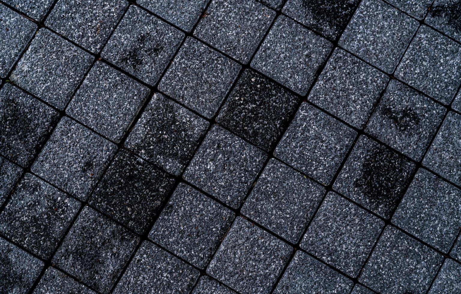 Black and grey rough paving stone texture background. Dark background for death, sad, hopeless and despair concept. Pavement architecture. Paving abstract texture. Paving slabs. Rough street floor. photo