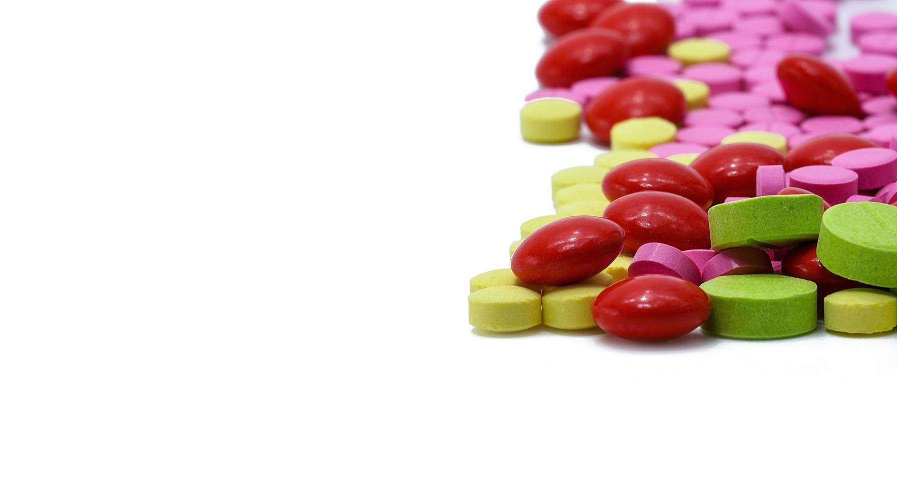 Colorful round tablets pills isolated on white background. Drug interactions concept. Pharmaceutical industry. Pharmacy product. Pharmacy drugstore. Global healthcare. Vitamins and supplements tablet. photo