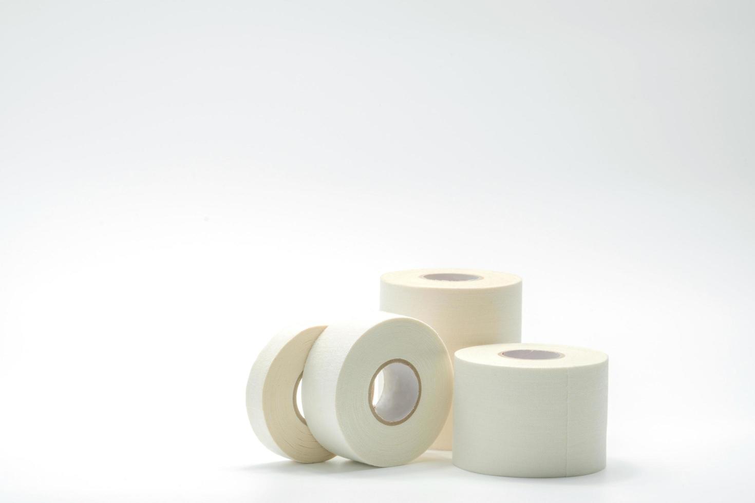 White sport tape isolated on white background. Athletic taping. Porous adhesive tape. Medical tape. Multipurpose porous tape for wound care and sprain. First aid medical supplies. Sport bandage. photo