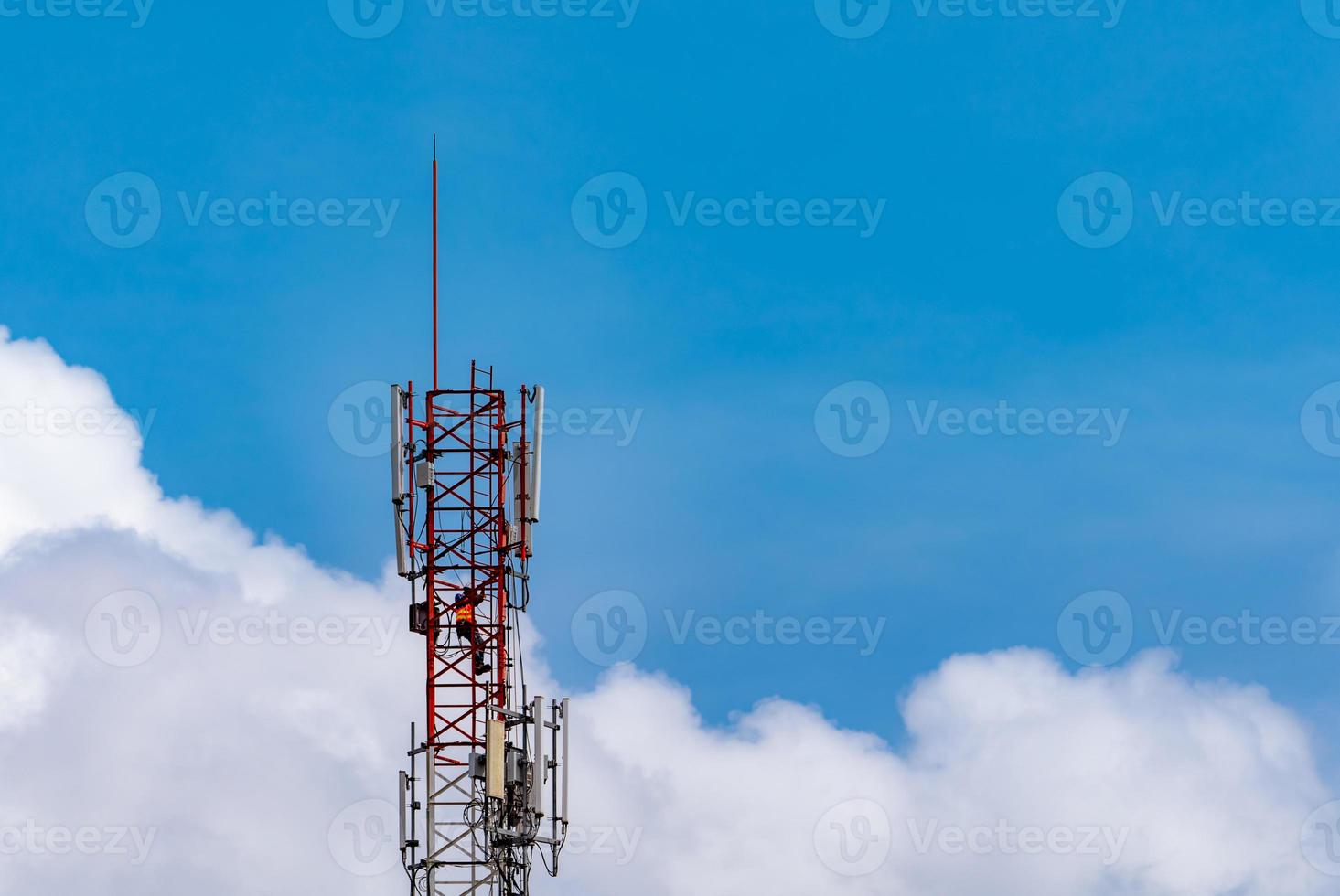 Telecommunication tower with blue sky and white clouds. Worker installed 5g equipment on telecommunication tower.Communication technology. Telecommunication industry. Mobile or telecom 5g network. photo