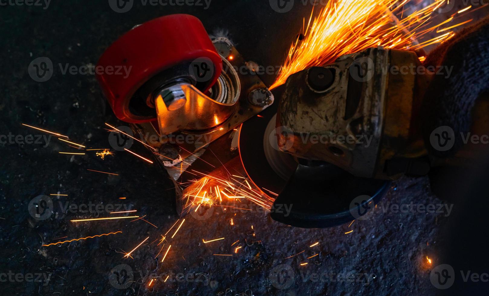 trabajador industrial usando amoladora angular cortando metal. trabajador que trabaja con amoladora angular y tiene chispas naranjas. herramienta para cortar y desbastar acero. seguridad en el lugar de trabajo industrial. industria metalúrgica. foto