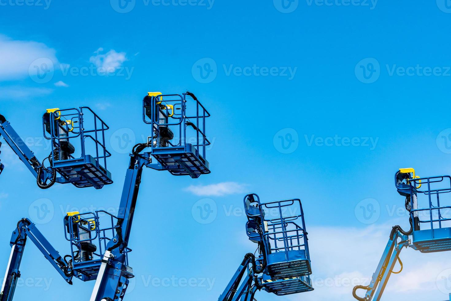 Articulated boom lift. Aerial platform lift. Telescopic boom lift against blue sky. Mobile construction crane for rent and sale. Maintenance and repair hydraulic boom lift service. Crane dealership. photo