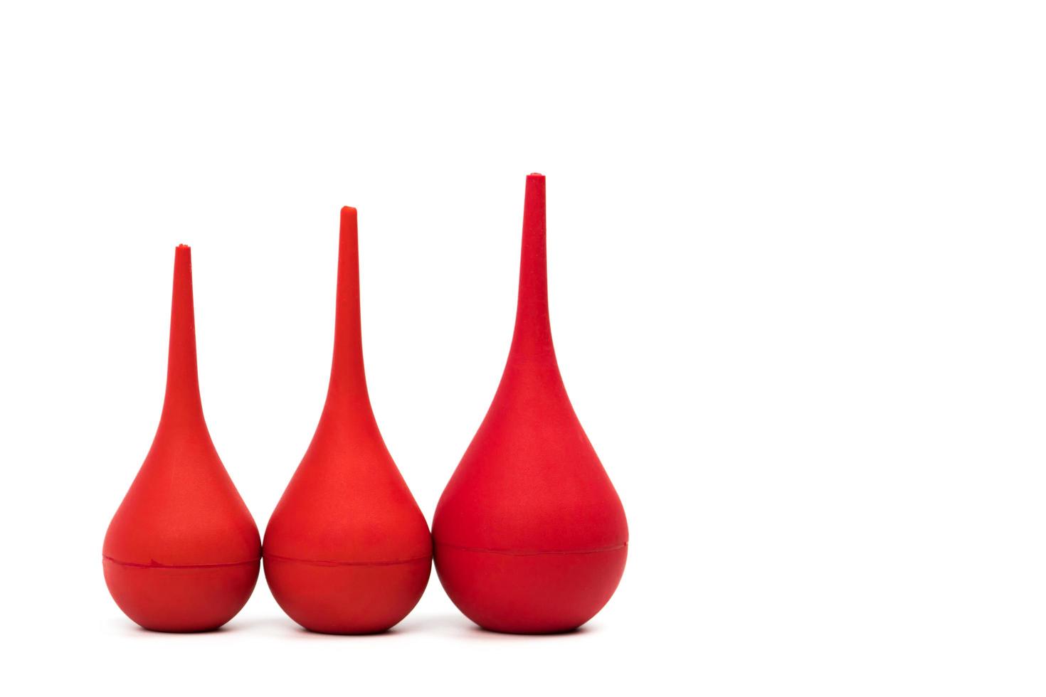 Red rubber syringe ball isolated on white background. Nasal aspirator. Baby ear syringe ball. Snot sucker and mucus sucker. Laboratory tool. Rubber suction syringe bulb. Ear washing squeeze bulb. photo