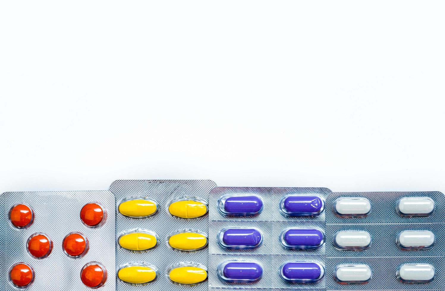 Tablets pills medicine in blister pack with frame pattern and space box for text. Colorful tablets pills with creative pattern on white background. Background for health care education. photo