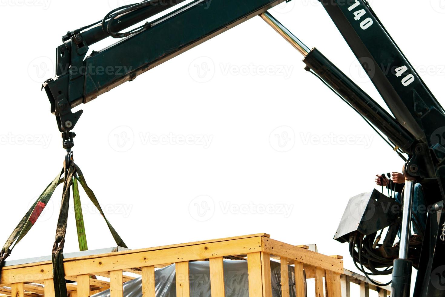 Worker working with mobile crane isolated on white background. Crane delivery machine in wooden box from truck to factory warehouse. Freight transport. Heavy goods. Warehouse and shipping business. photo