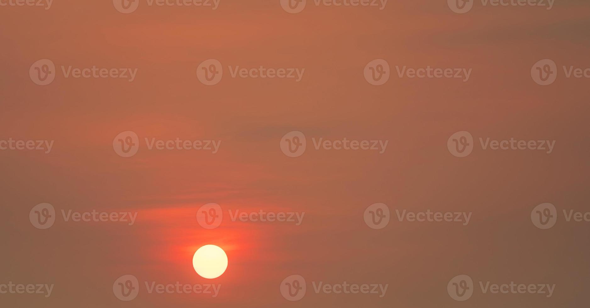 Round big sun and red sunset sky in the evening with space for inspiration quote. Beauty in nature. Beautiful summer sunset sky. Tranquil and peaceful background. Panorama scene of red sky. photo