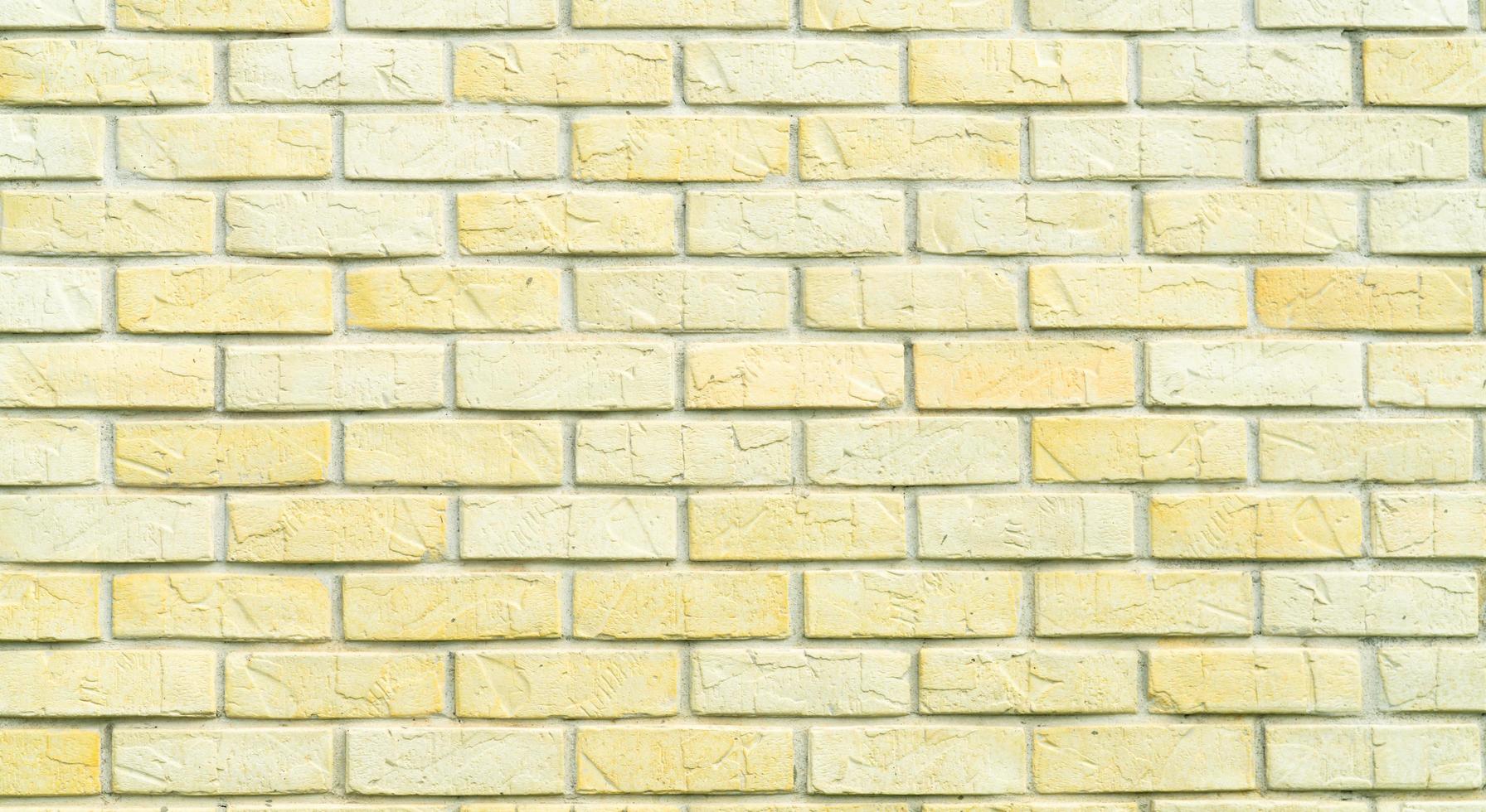 Yellow and white brick wall texture background with space for text. Old bricks wallpaper. Home interior decoration. Architecture concept photo