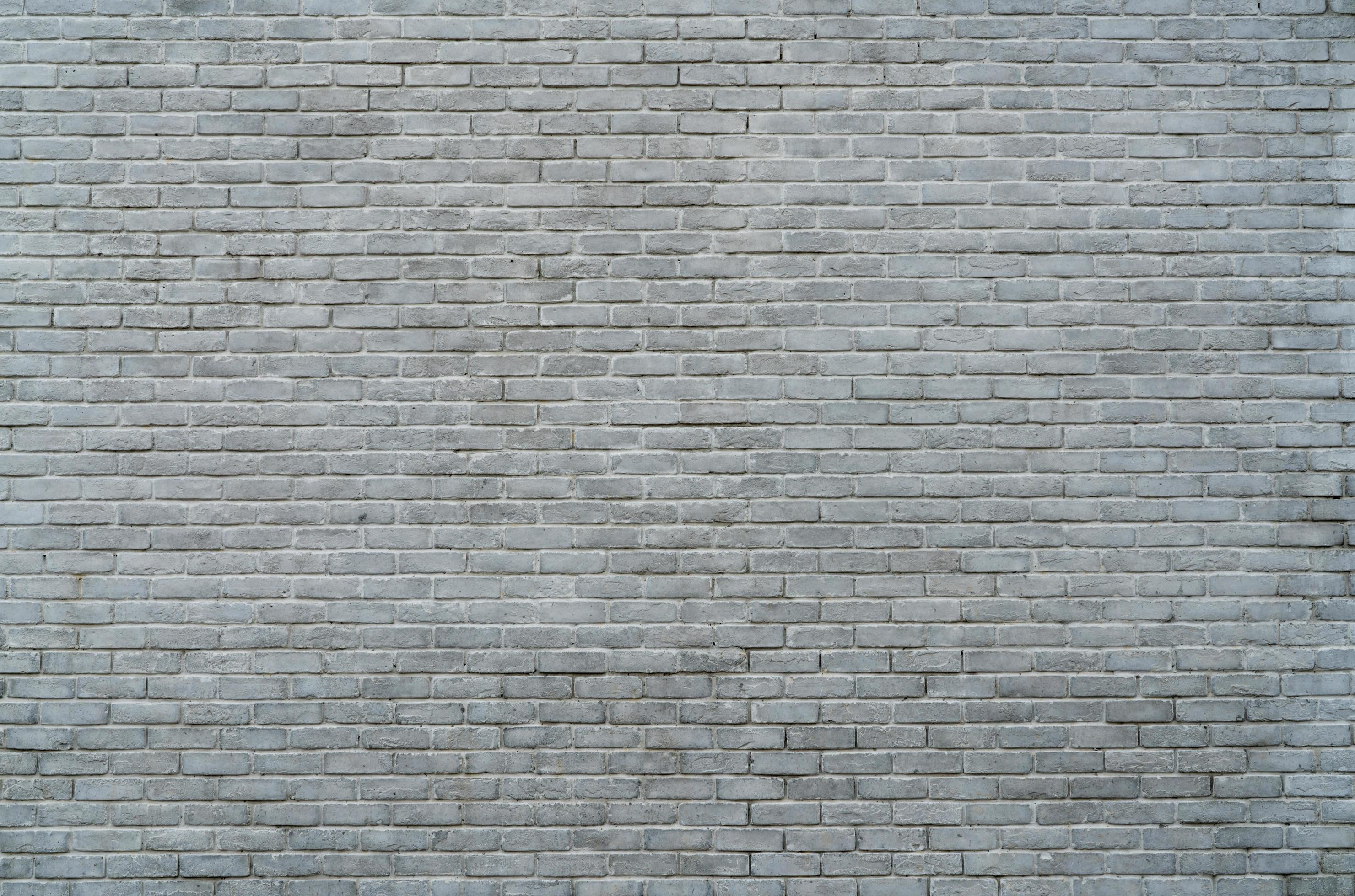 White and grey brick wall texture background with space for text. White
