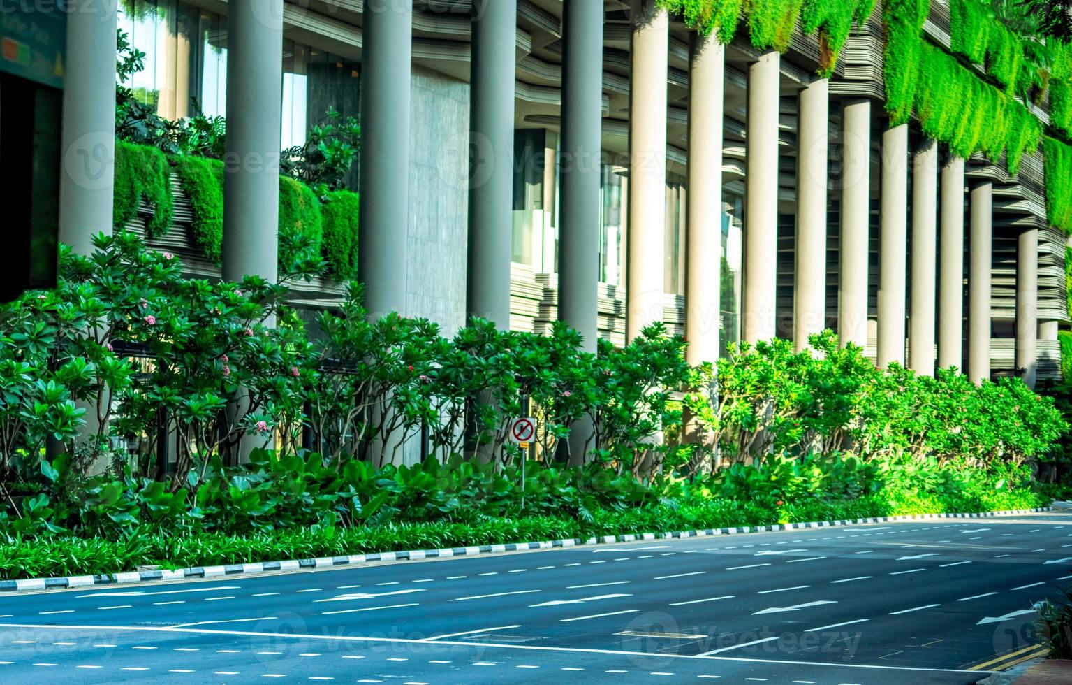 Eco friendly building with vertical garden in modern city. Green plant and tree forest and ivy on facade on sustainable building. Energy saving architecture with vertical garden. Clean environment. photo