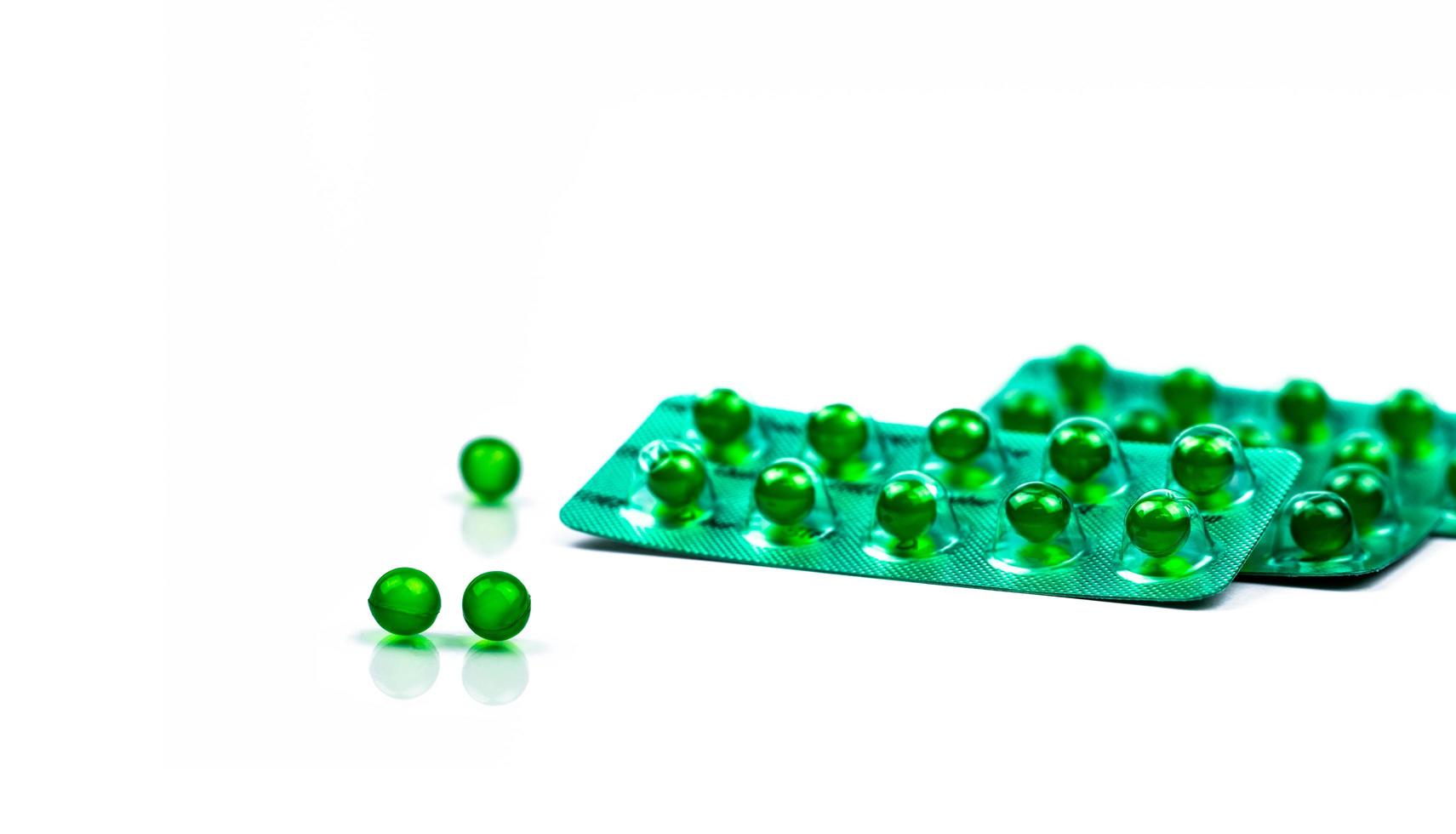 Green round soft capsule pills isolated on white background with copy space. Ayurvedic medicine for indigestion, gas and acidity. Herbal medicine made from Mentha oil and spearmint oil from India photo