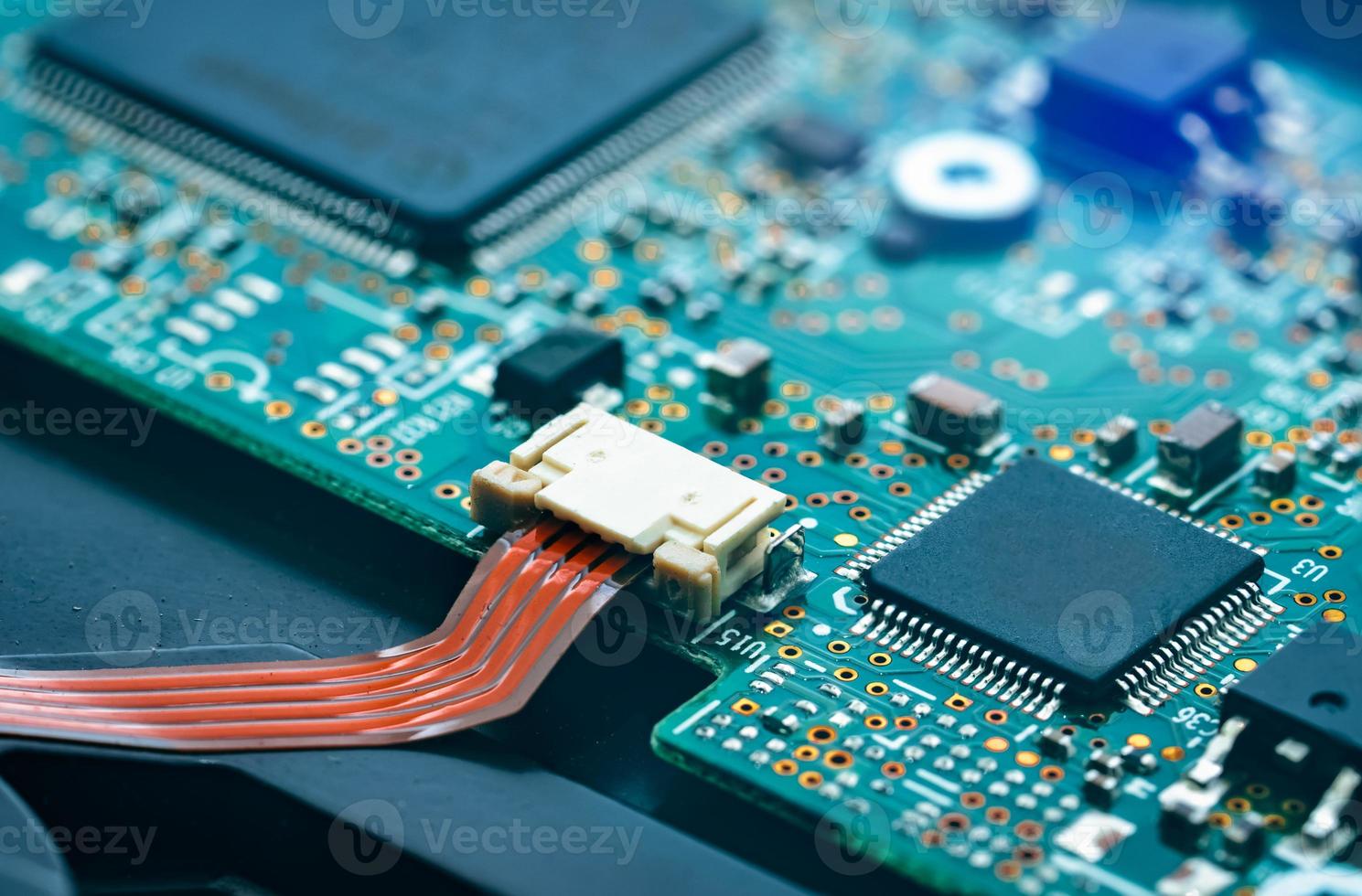 Electronic circuit board. Mainboard of computer. Computer integrated circuit board. Detail of electronic circuit board. Memory of digital information hardware. Electronic engineering technology. photo