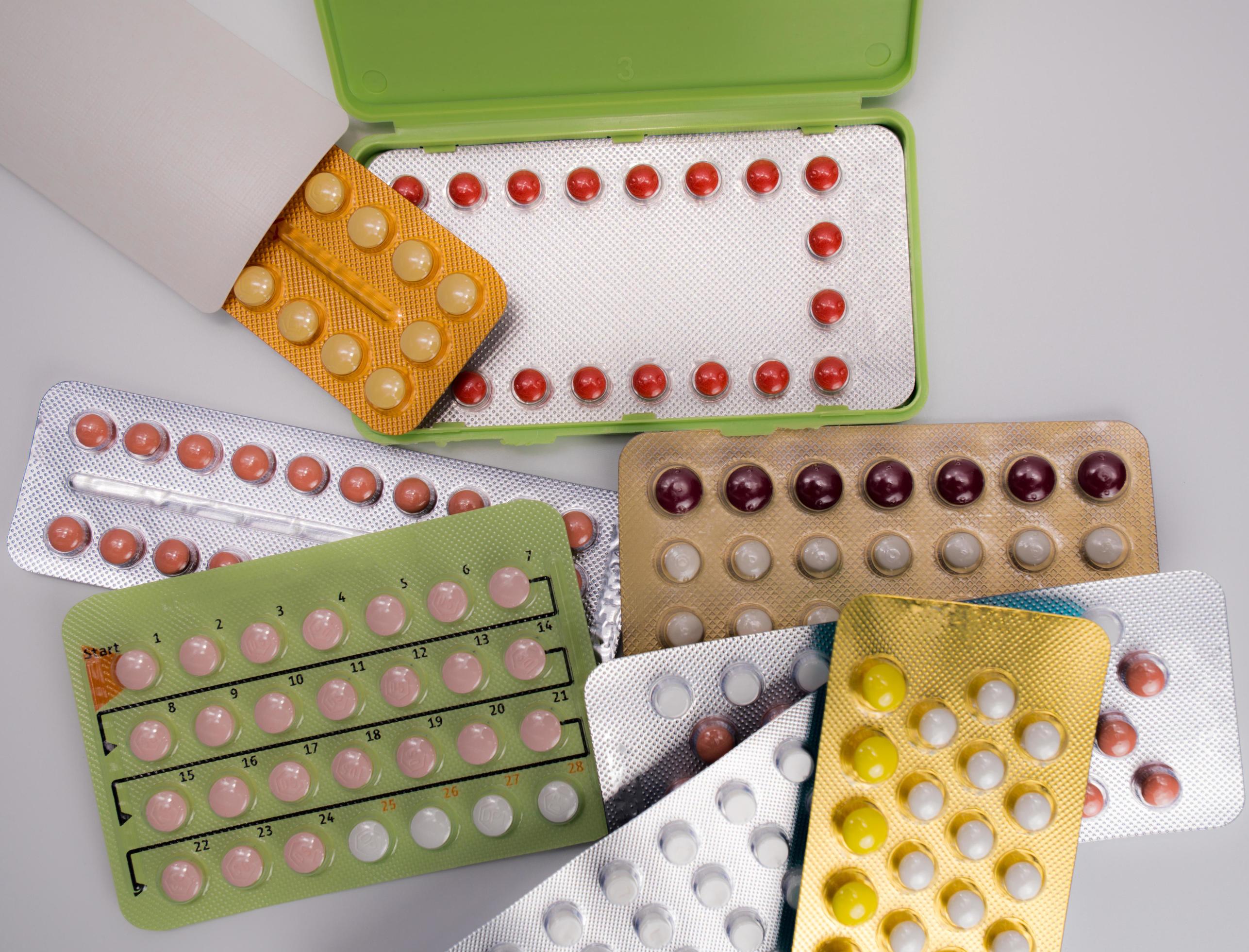 Top view pile of contraceptive pills in blister pack. Birth control