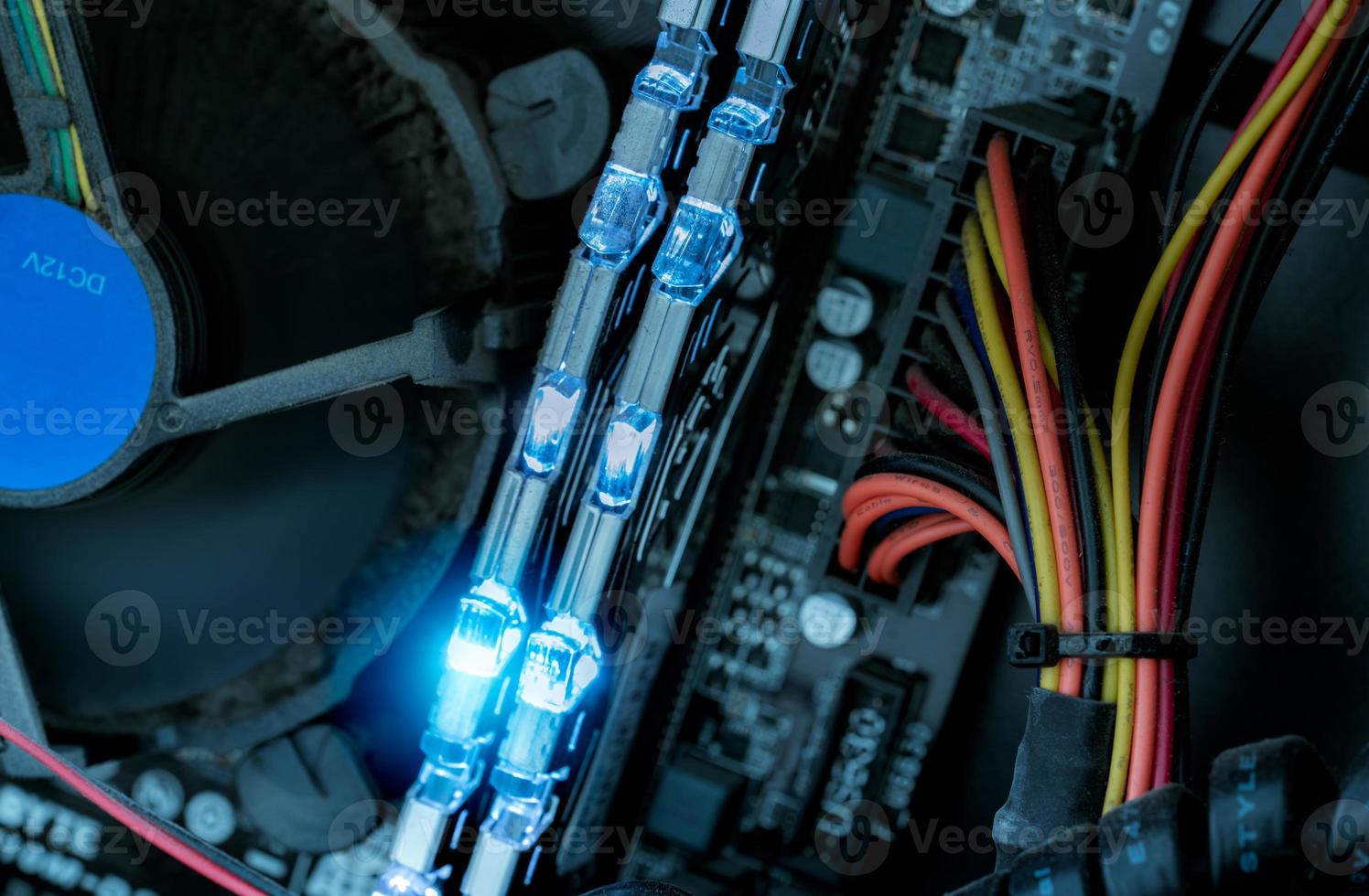 RAM memory in computer motherboard. Inside desktop PC plenty of dust. Dirty PC need to clean. PC system. Computer hardware. Electronic chip. PC RAM, fan, and cable wire in CPU of desktop computer. photo