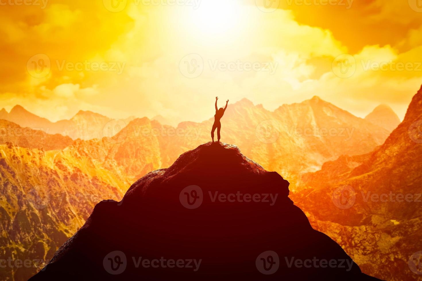 Happy woman on peak of the mountain enjoying the success, freedom and bright future. photo