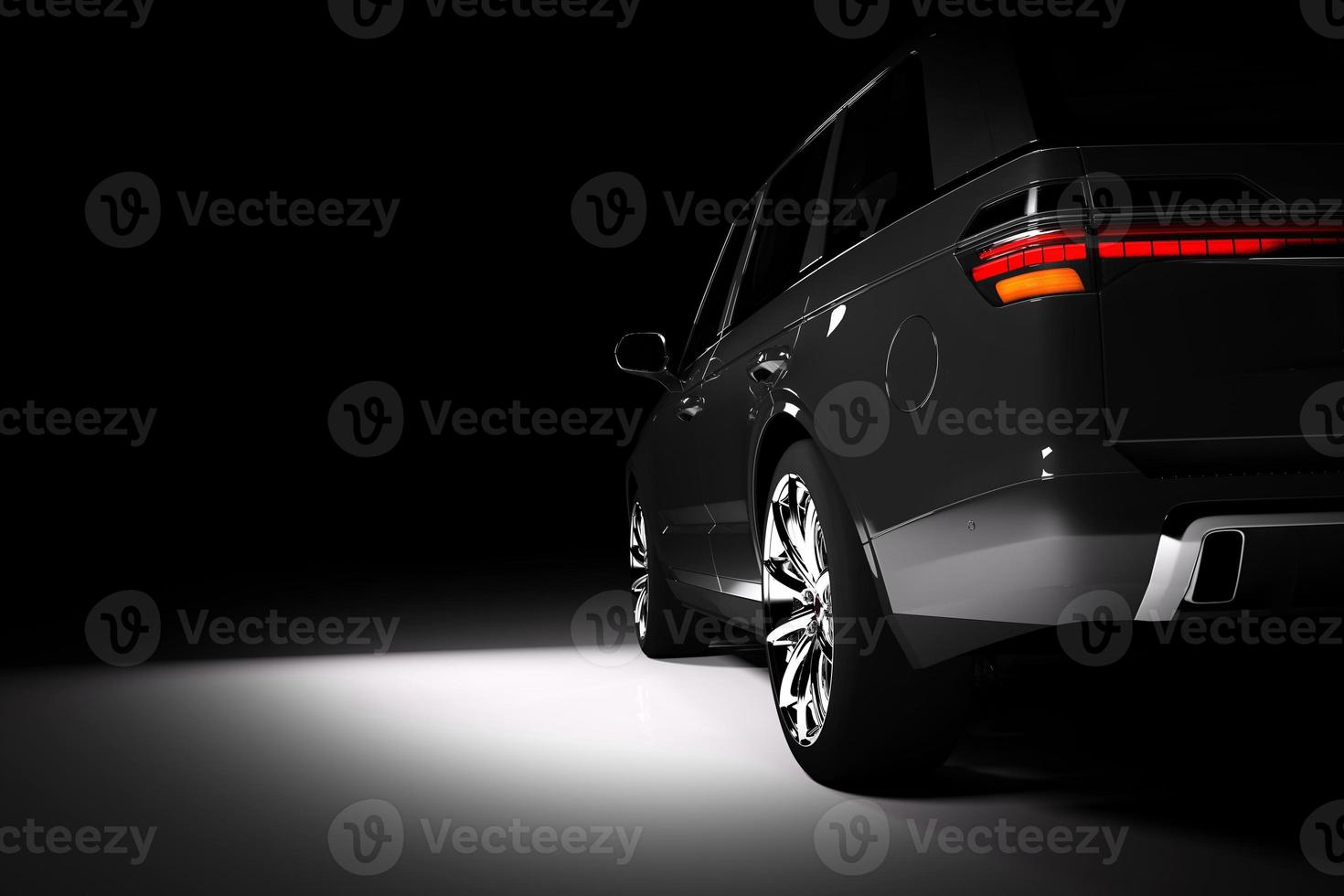 Back view of modern black SUV car in a spotlight photo