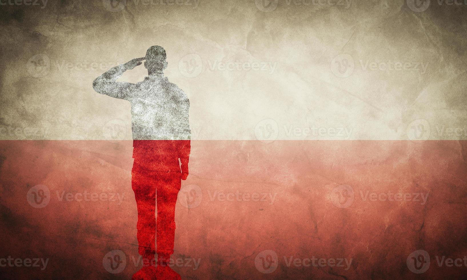 Polish grunge flag with soldier silhouette. photo