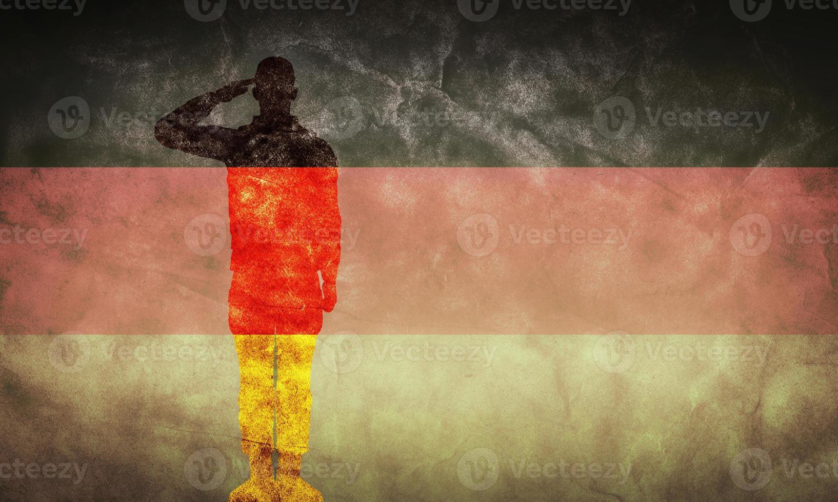 German grunge flag with soldier silhouette. photo